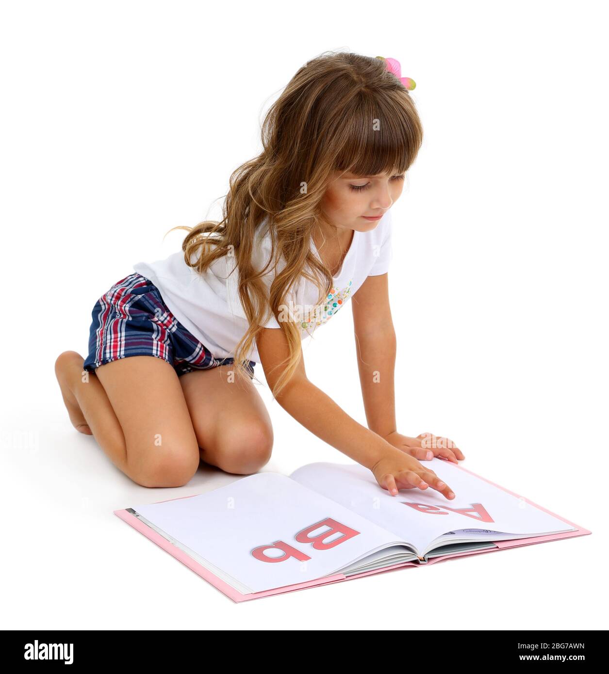Little girl sitting on floor with book isolated on white Stock Photo ...