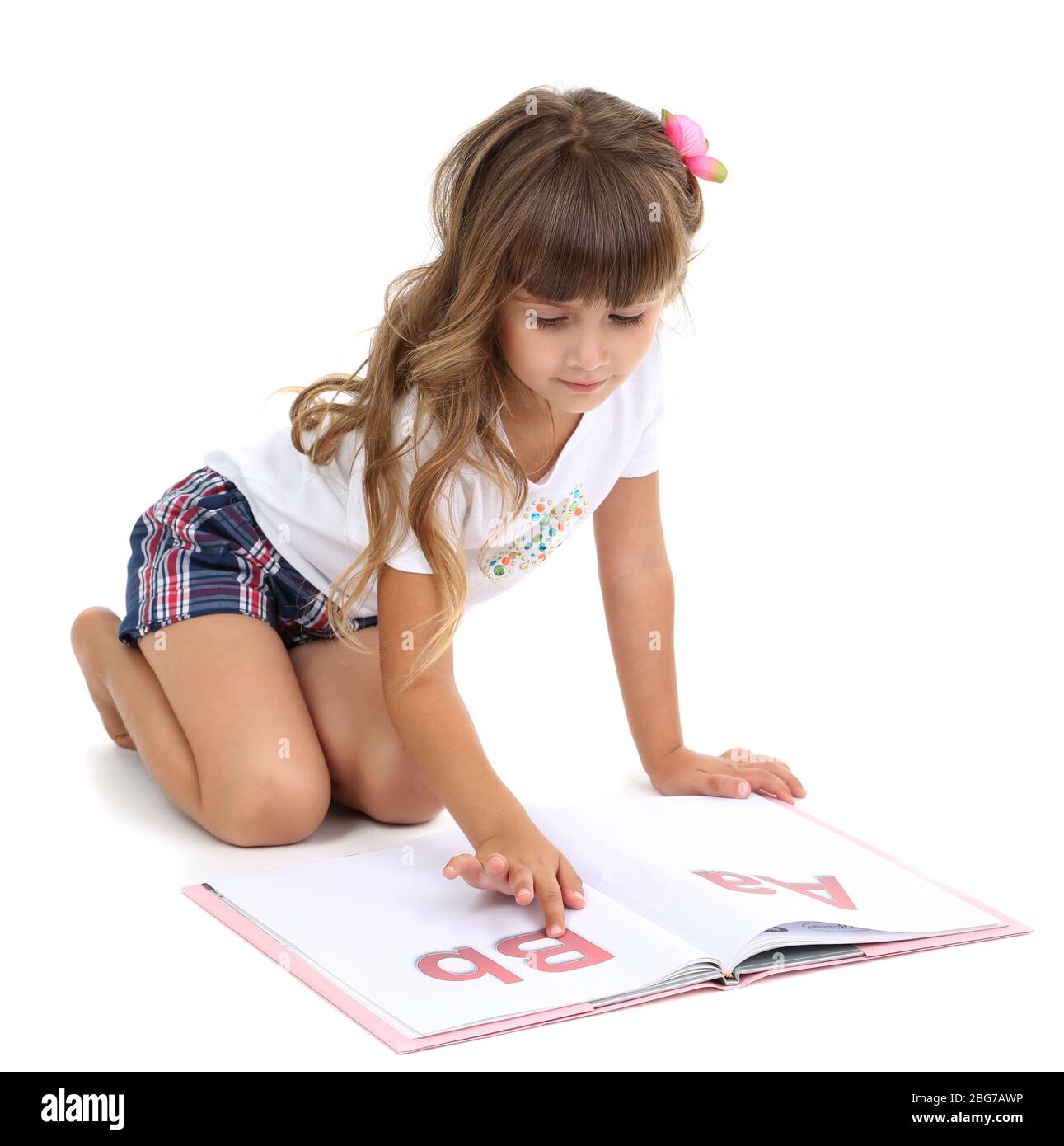 Little girl sitting on floor with book isolated on white Stock Photo ...