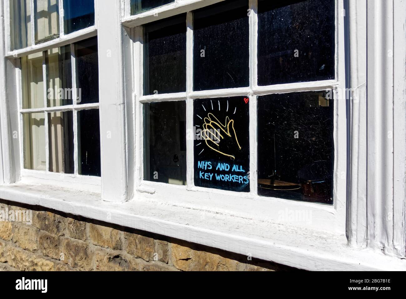 A Clap for NHS and Key Workers Sign in a house window in Warminster, Wiltshire, UK Stock Photo