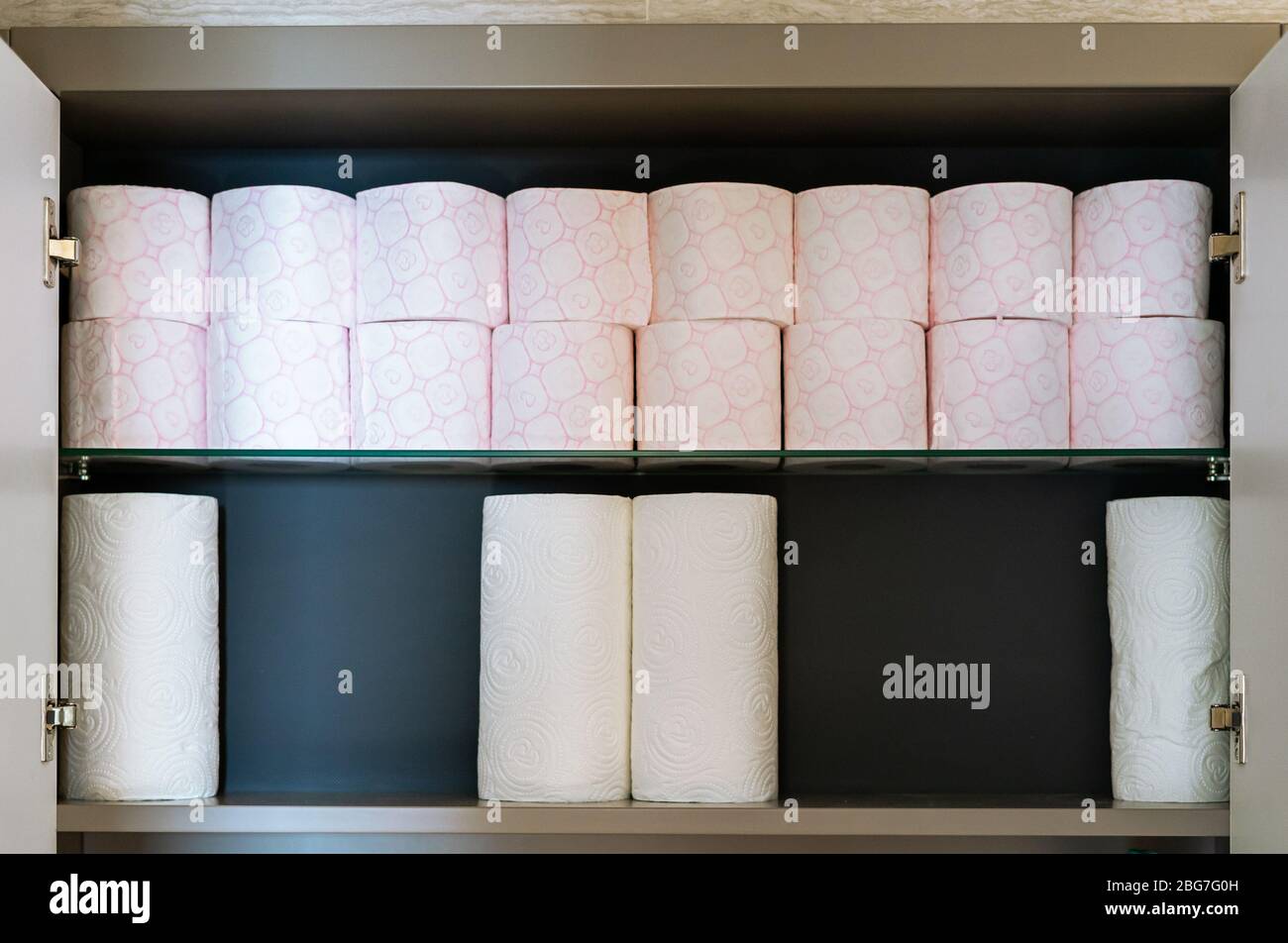 Stock of toilet paper hidden in bathroom closet Stock Photo