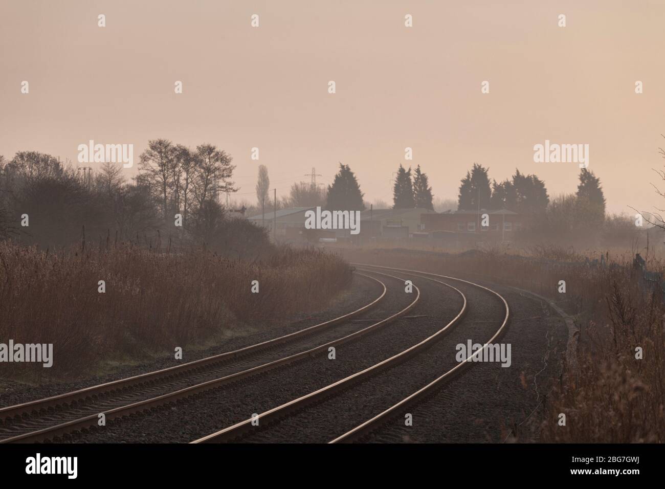 Sweeping bend on the freight only Network Rail  Warrington low level freight only railway line on a misty morning.  UK Stock Photo