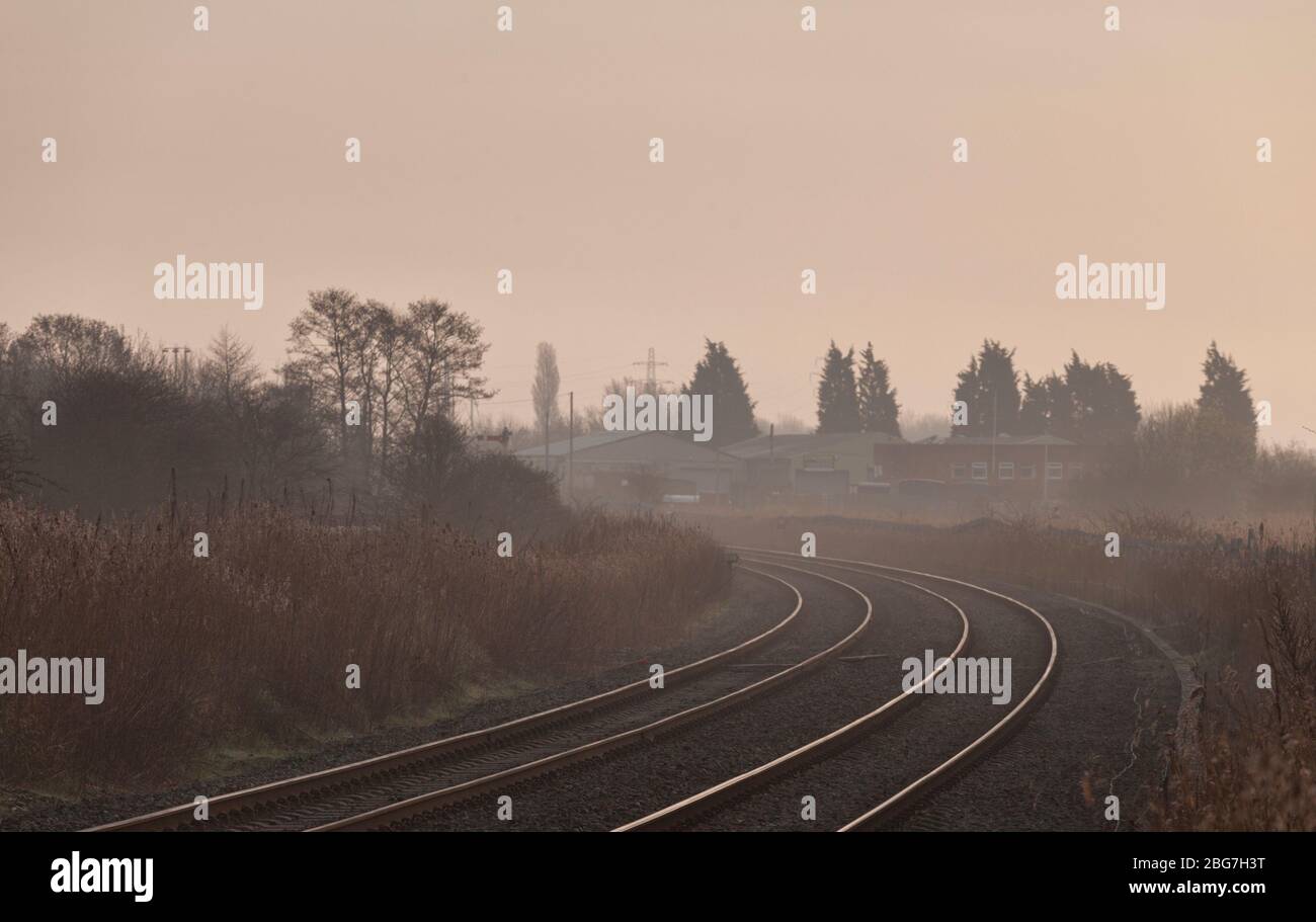 Sweeping bend on the freight only Network Rail  Warrington low level freight only railway line on a misty morning.  UK Stock Photo