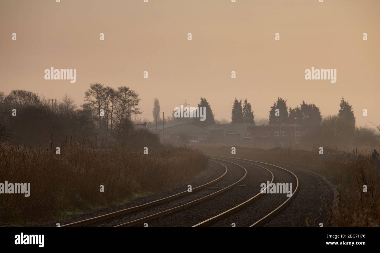 Sweeping bend on the freight only Network Rail  Warrington low level freight only railway line on a misty morning.  UK Stock Photo