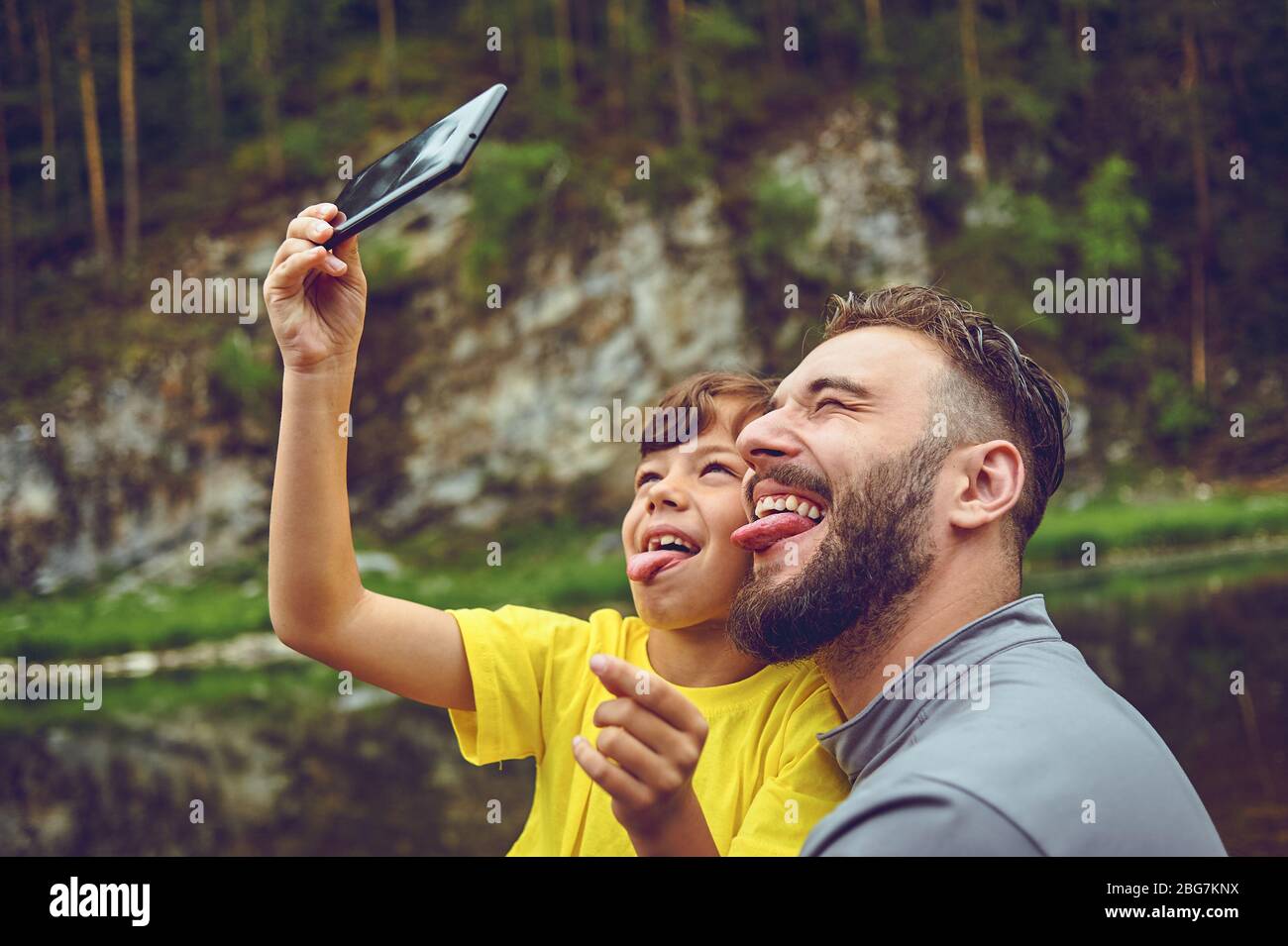 Having fun. Father example of noble human. Taking selfie with son. Child riding on dads shoulders. Happiness being father of boy. Stock Photo