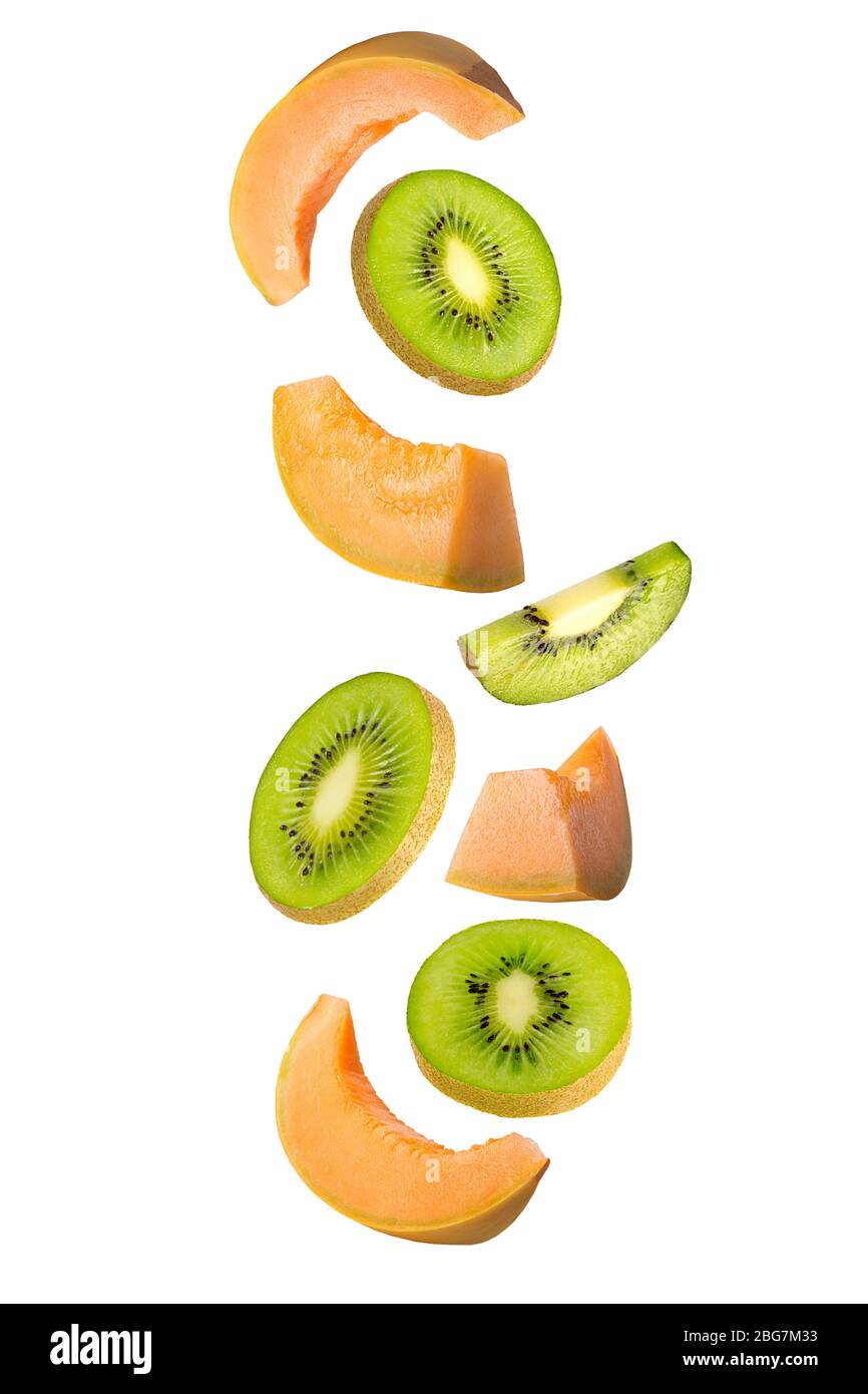 Falling kiwi and melon isolated on white background. Stock Photo