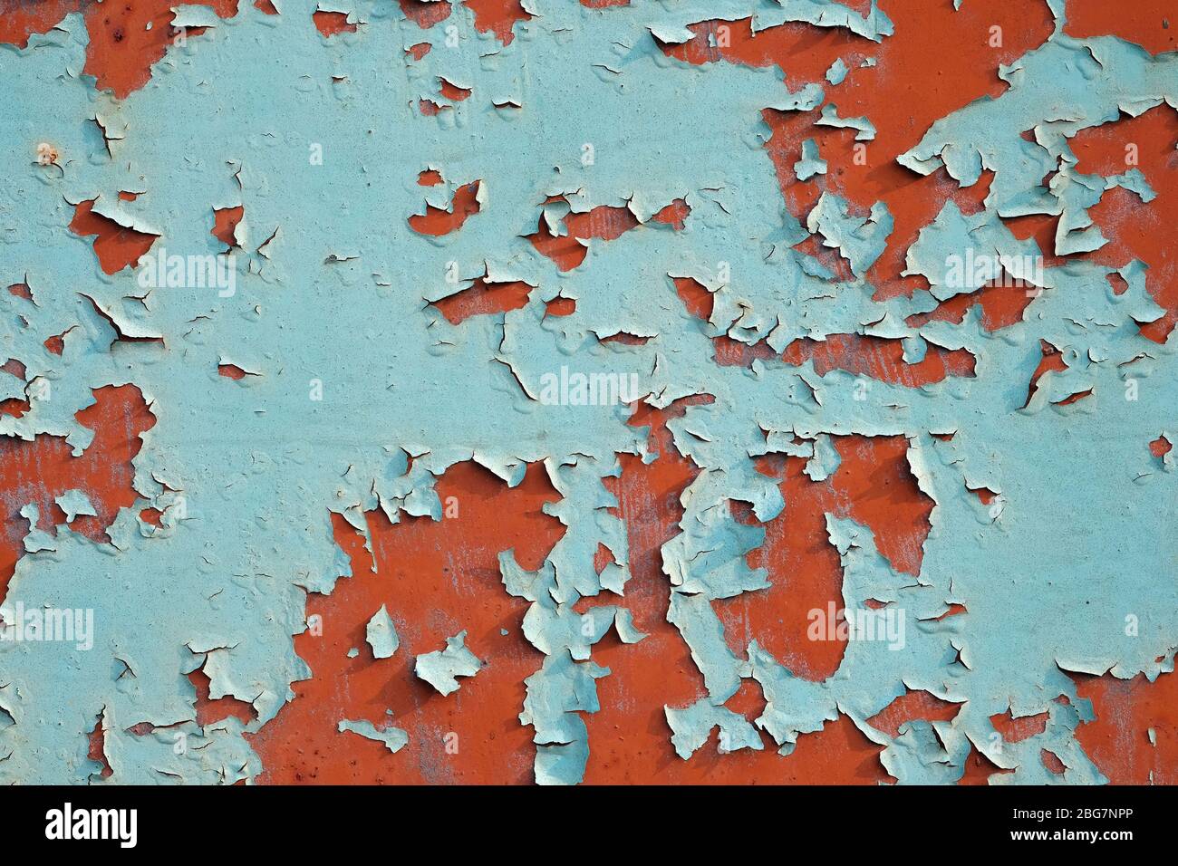 Peeling paint from a metal surface, background. Texture Blue paint