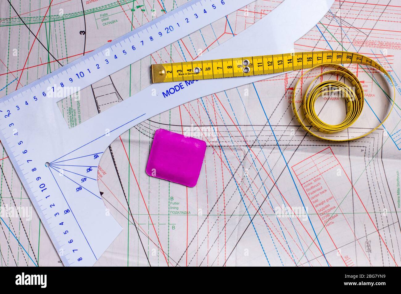 Sewing tools, tape measure, ruler and chalk on a sewing pattern Stock Photo Alamy