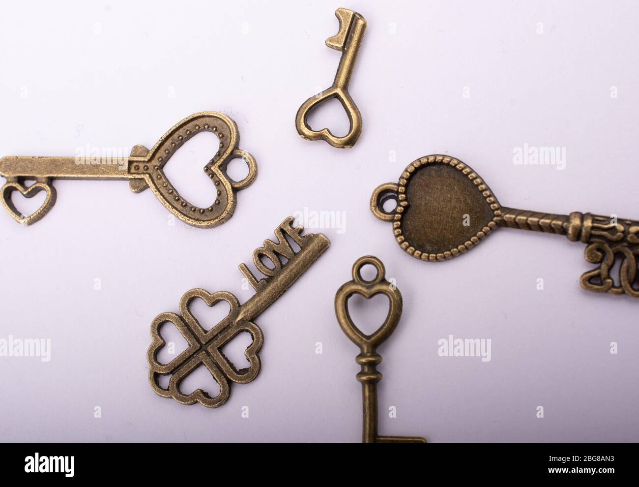 Heart shaped retro metal keys on white background Stock Photo - Alamy