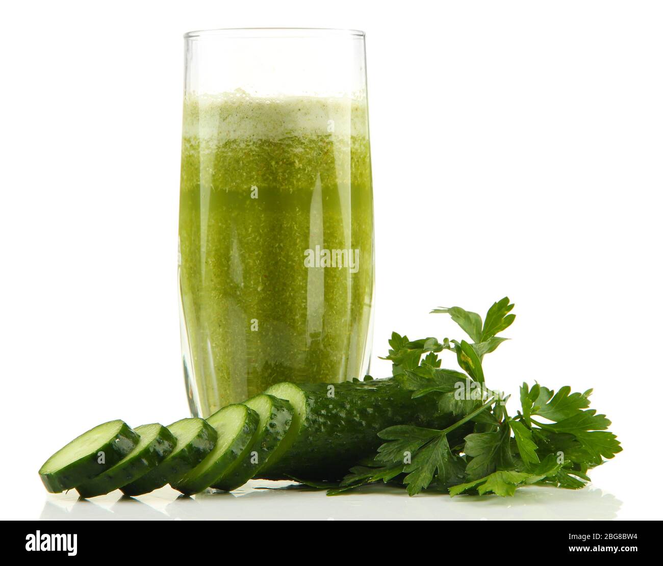 Glass of green vegetable juice and cucumber isolated on white Stock ...