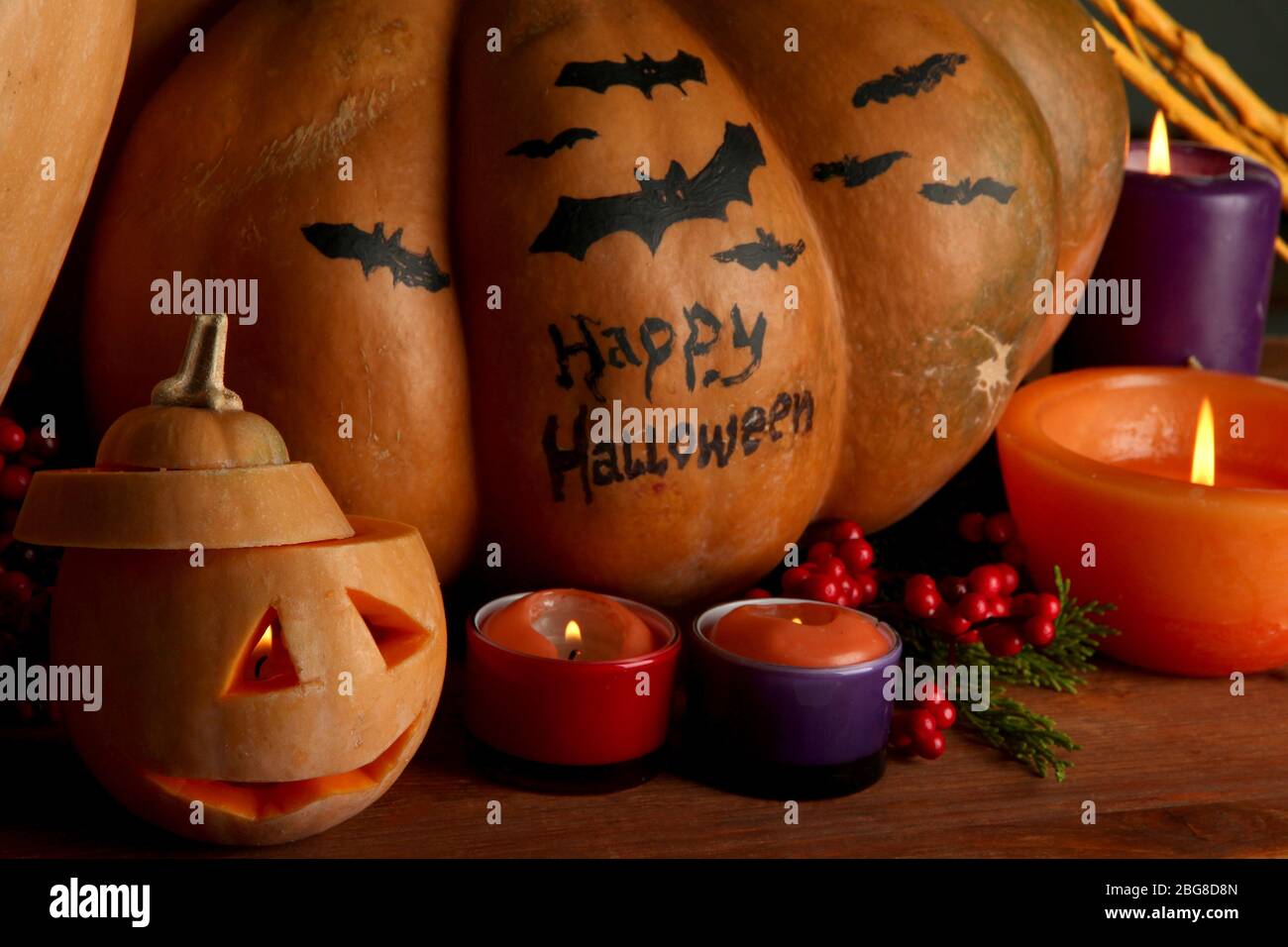Composition for Halloween with pumpkins and candles on dark background ...