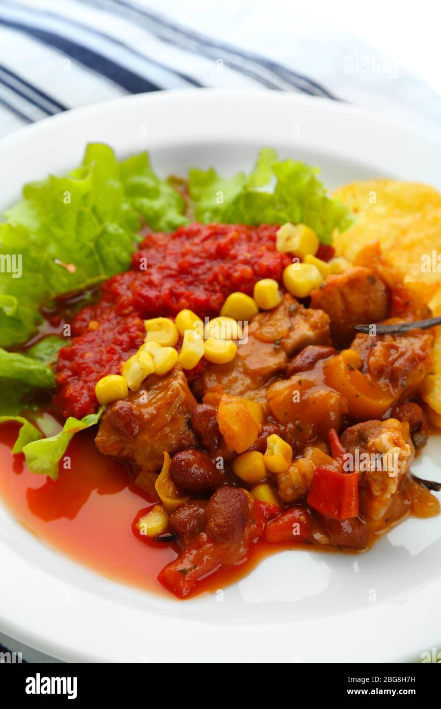 Chili Corn Carne - traditional mexican food, on white plate, on napkin ... Chili Corn Carne - traditional mexican food, on white plate, on napkin ...