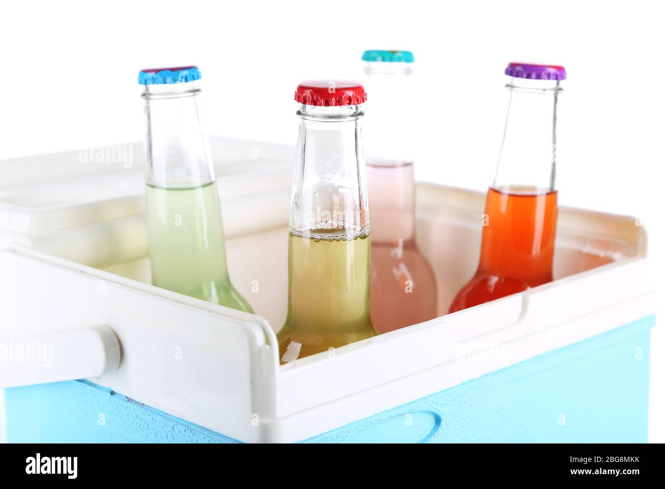 Drinks in glass bottles in mini fridge isolated on white Stock Photo