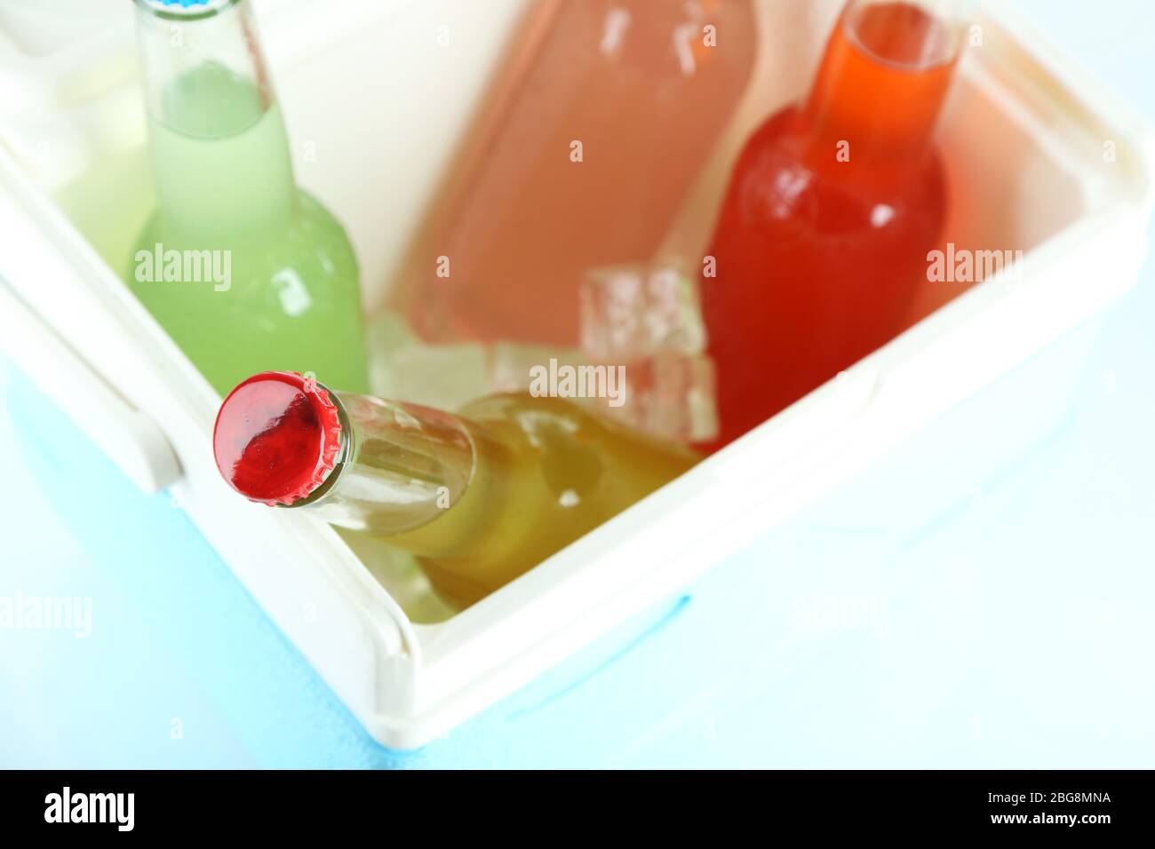 Drinks in glass bottles in mini fridge close up Stock Photo