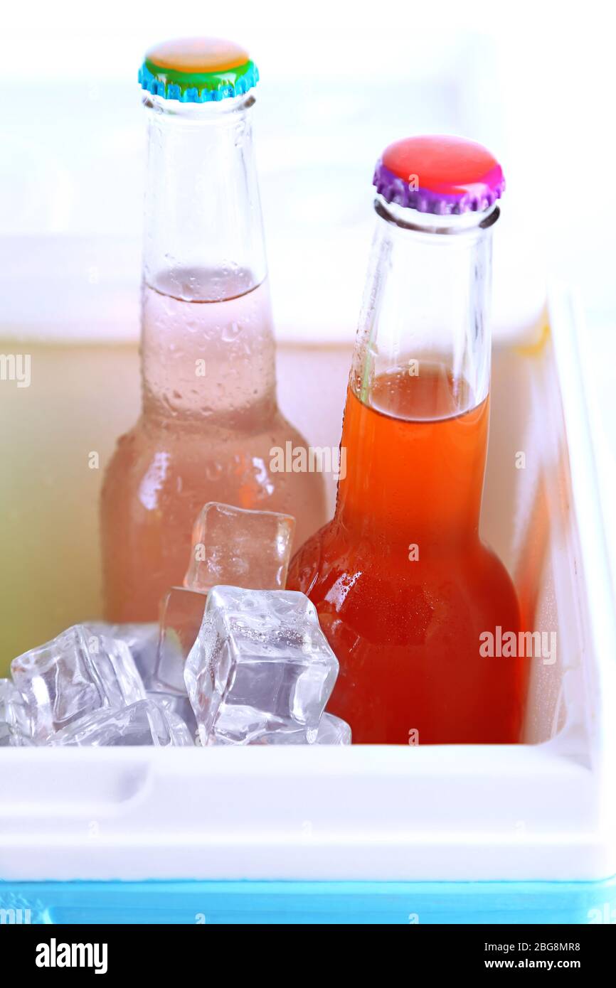 Drinks in glass bottles in mini fridge close up Stock Photo
