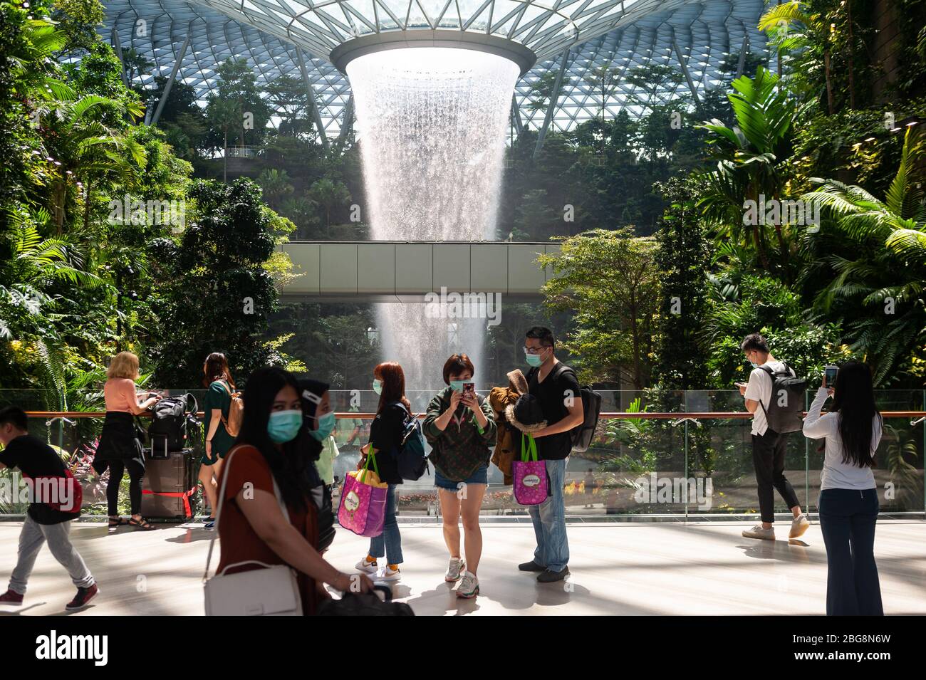 31.01.2020, Singapore, Republic of Singapore, Asia - People are seen in front of the vortex indoor waterfall at Changi Airport's new Jewel Terminal. Stock Photo