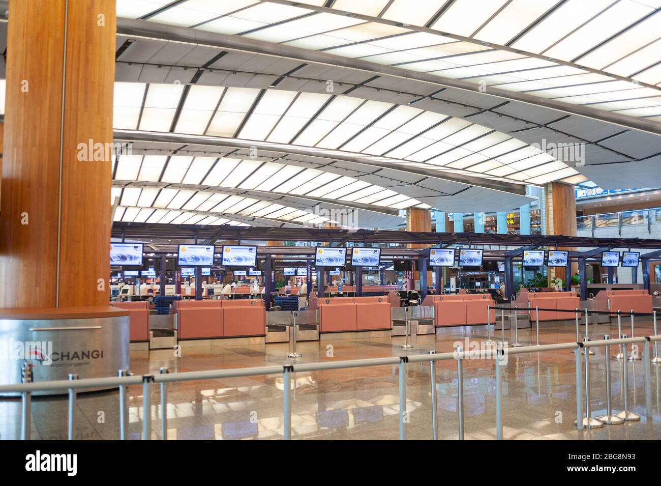 28.03.2020, Singapore, Republic of Singapore, Asia - Closed check-in counters in the empty departure hall of Terminal 2 at Changi Airport. Stock Photo