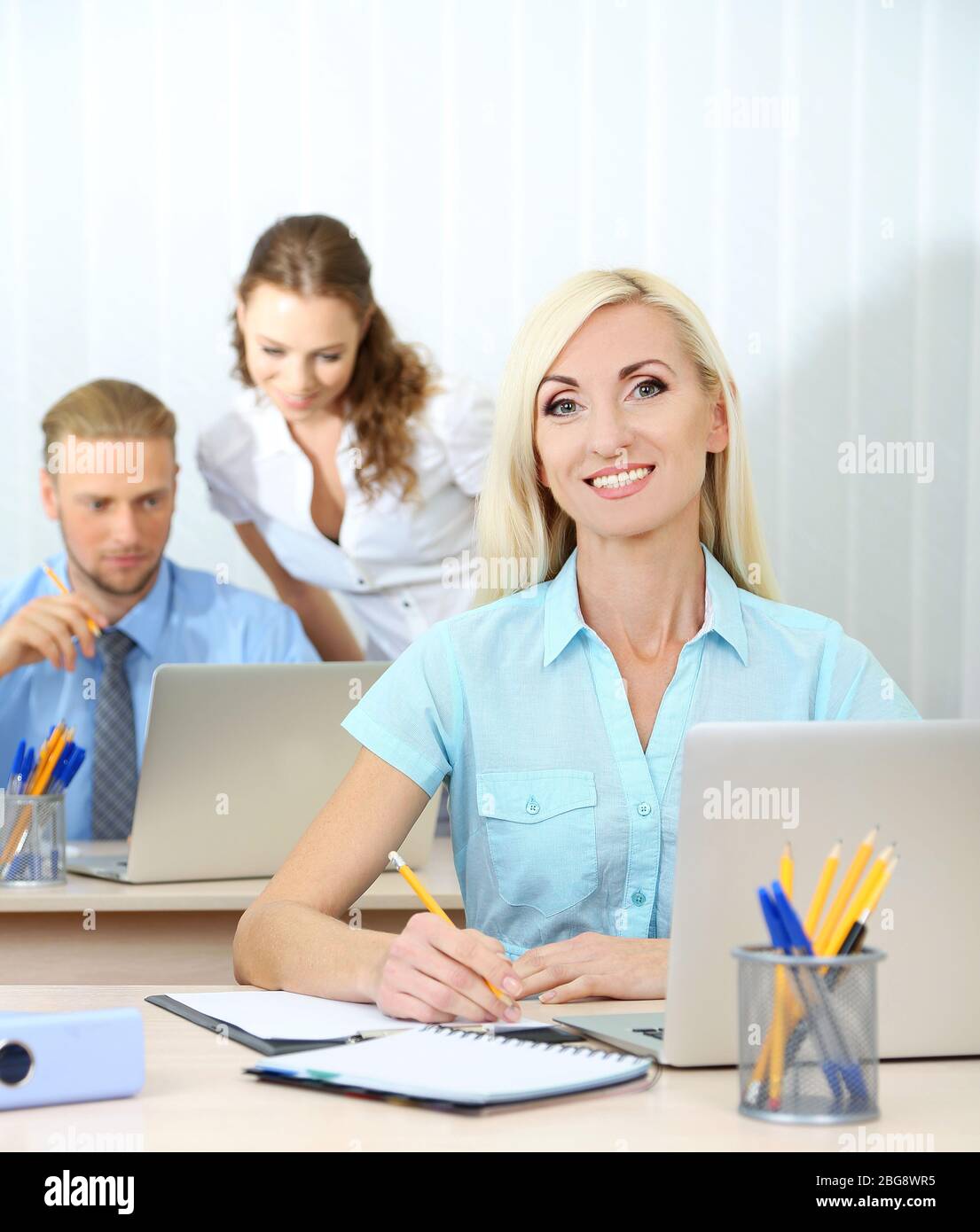 Office workers in workplace Stock Photo Alamy