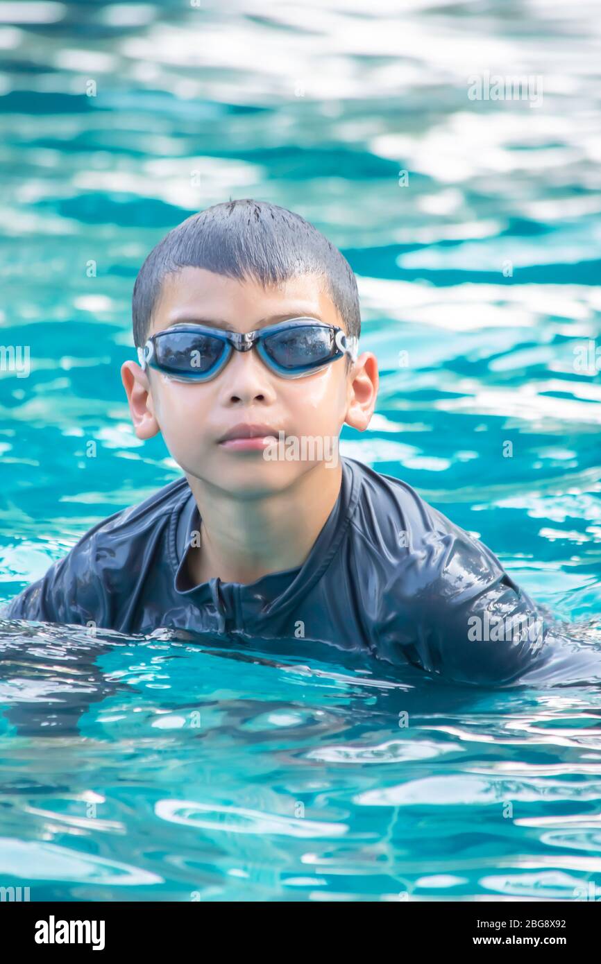 Portrait Asian boy wearing swimming goggles in the pool Stock Photo Alamy