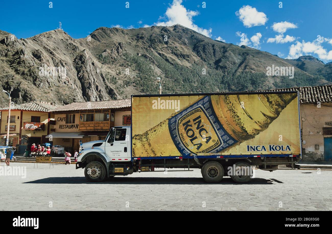 Truck with Inca Kola marketing poster parked in front of a building in a Peruvian village near Inca Trail Stock Photo