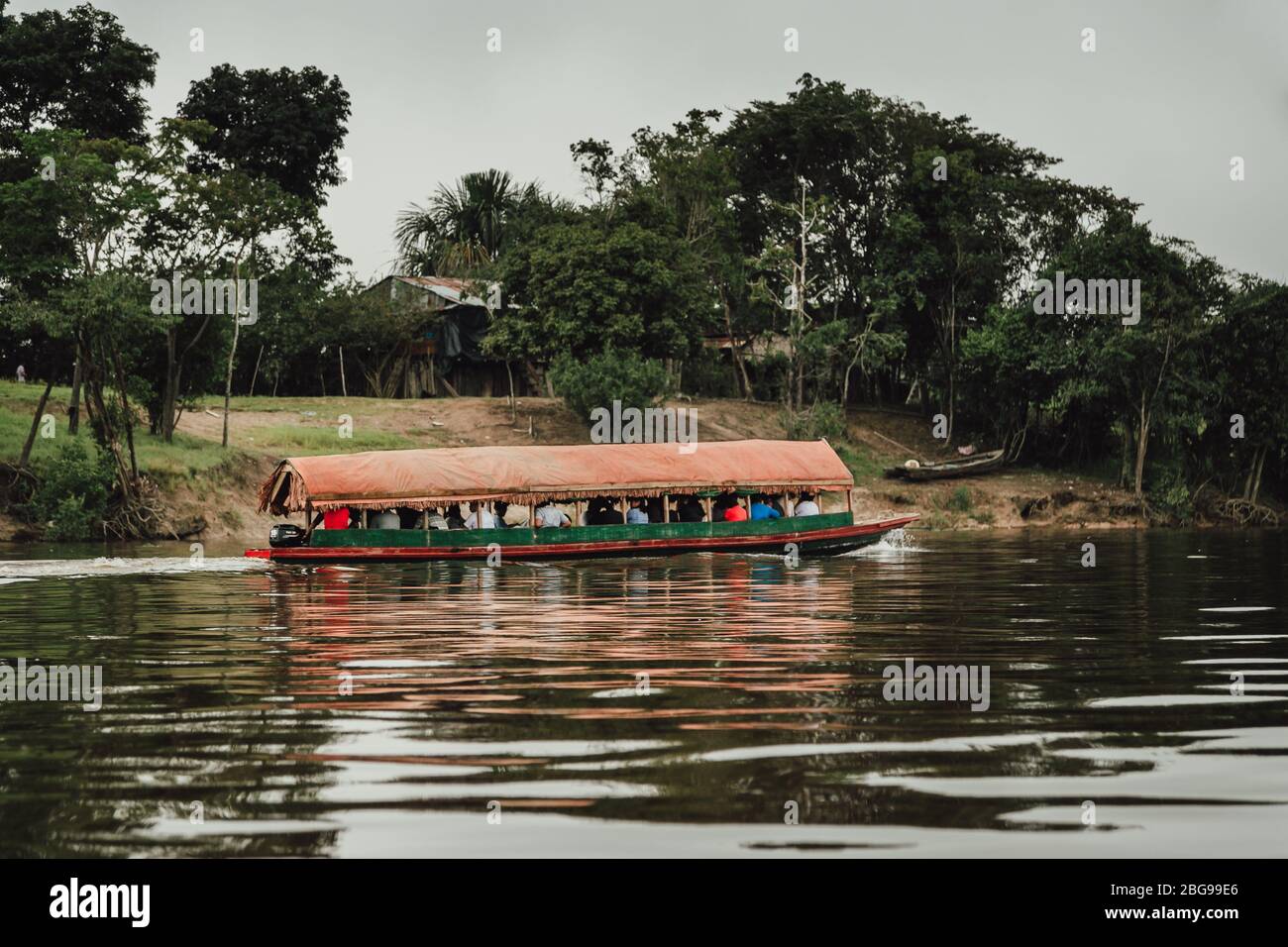 Traditional boat on Amazon river full of passengers, transporting people to nearby villages, near Iquitos, Loreto Region, Peru Stock Photo