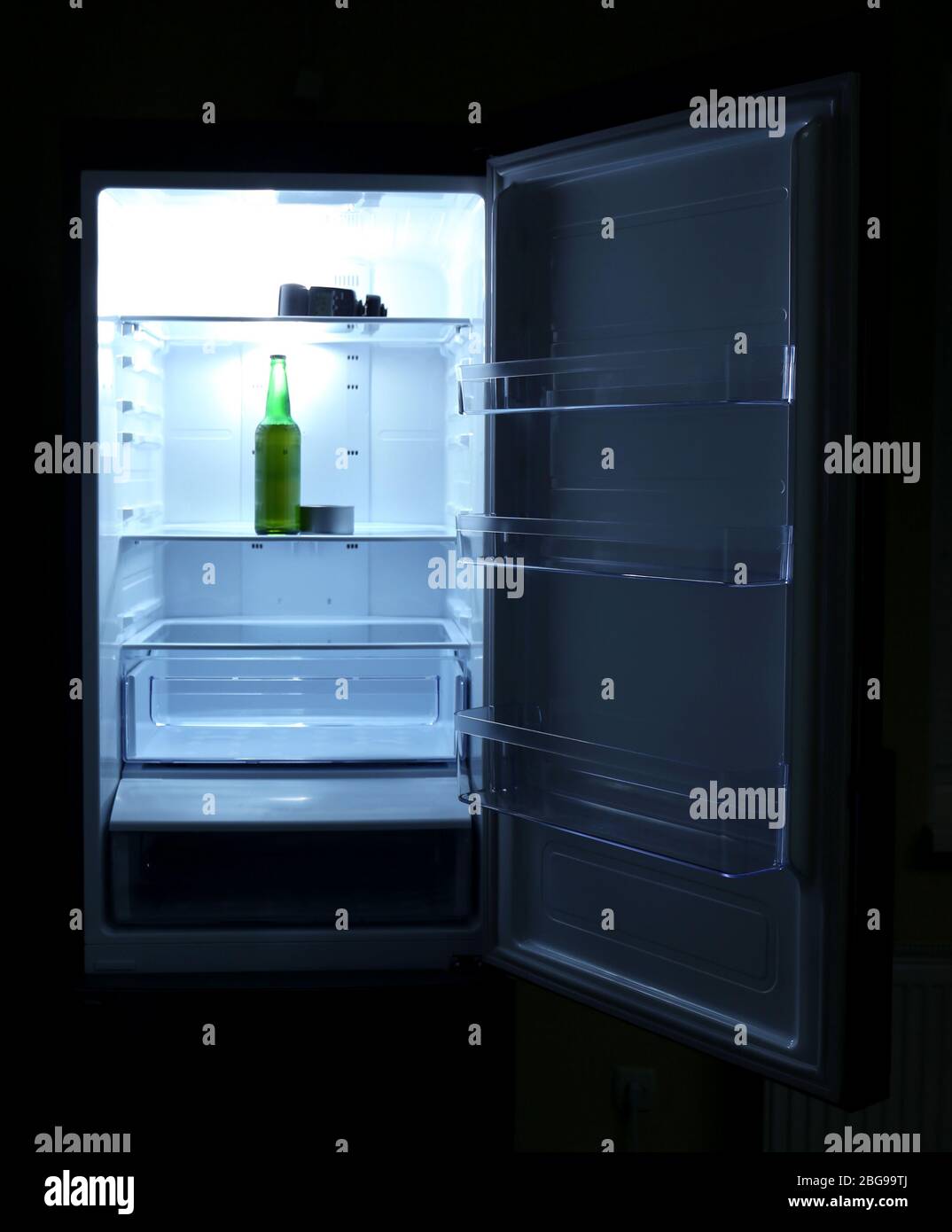 One beer bottle and canned tune in open empty refrigerator bachelor