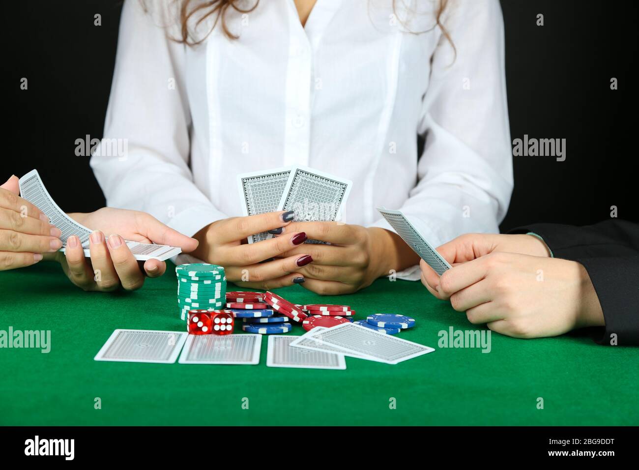 People playing cards at table Stock Photo