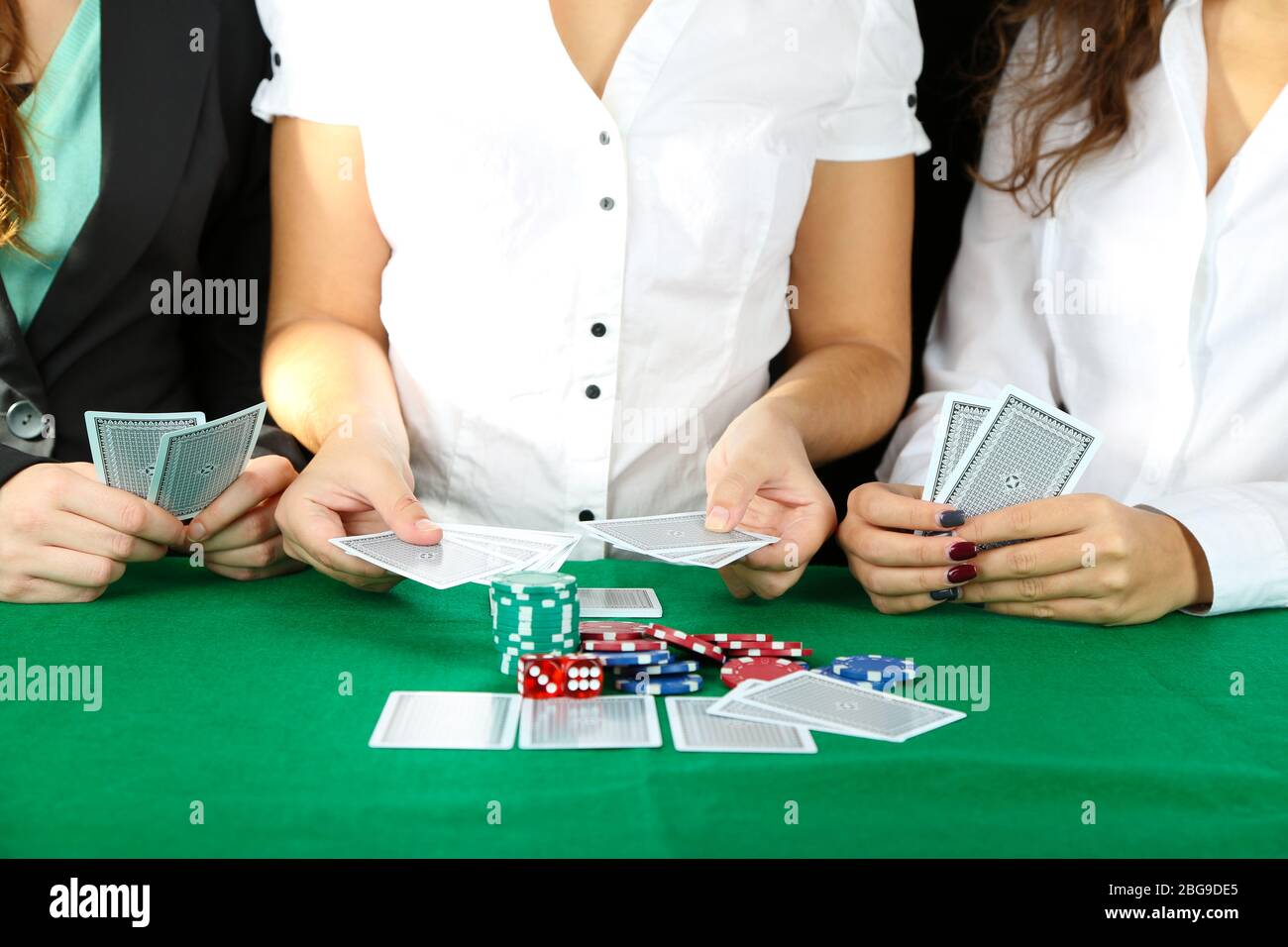 People playing cards at table Stock Photo