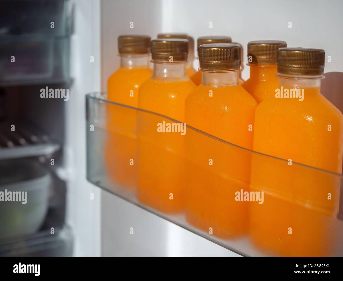 Orange juice bottles in refrigerator Stock Photo - Alamy