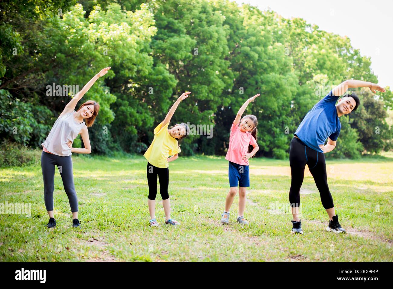 happy asian young family exercising  together at the park Stock Photo