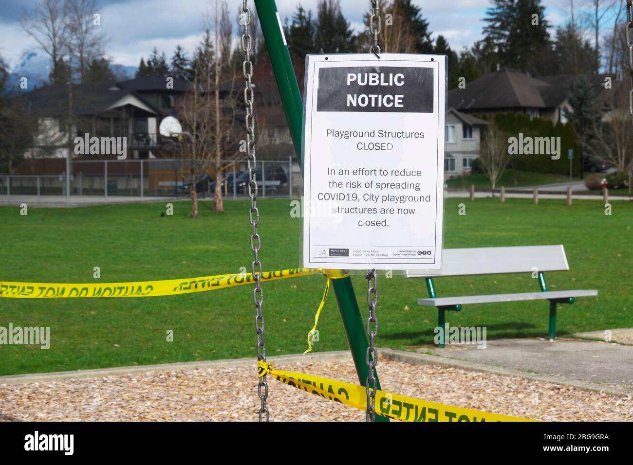 Public Notice Sign Posted in a Playground Advising of Playground Structures Closure During Covid19 Pandemic. Stock Photo