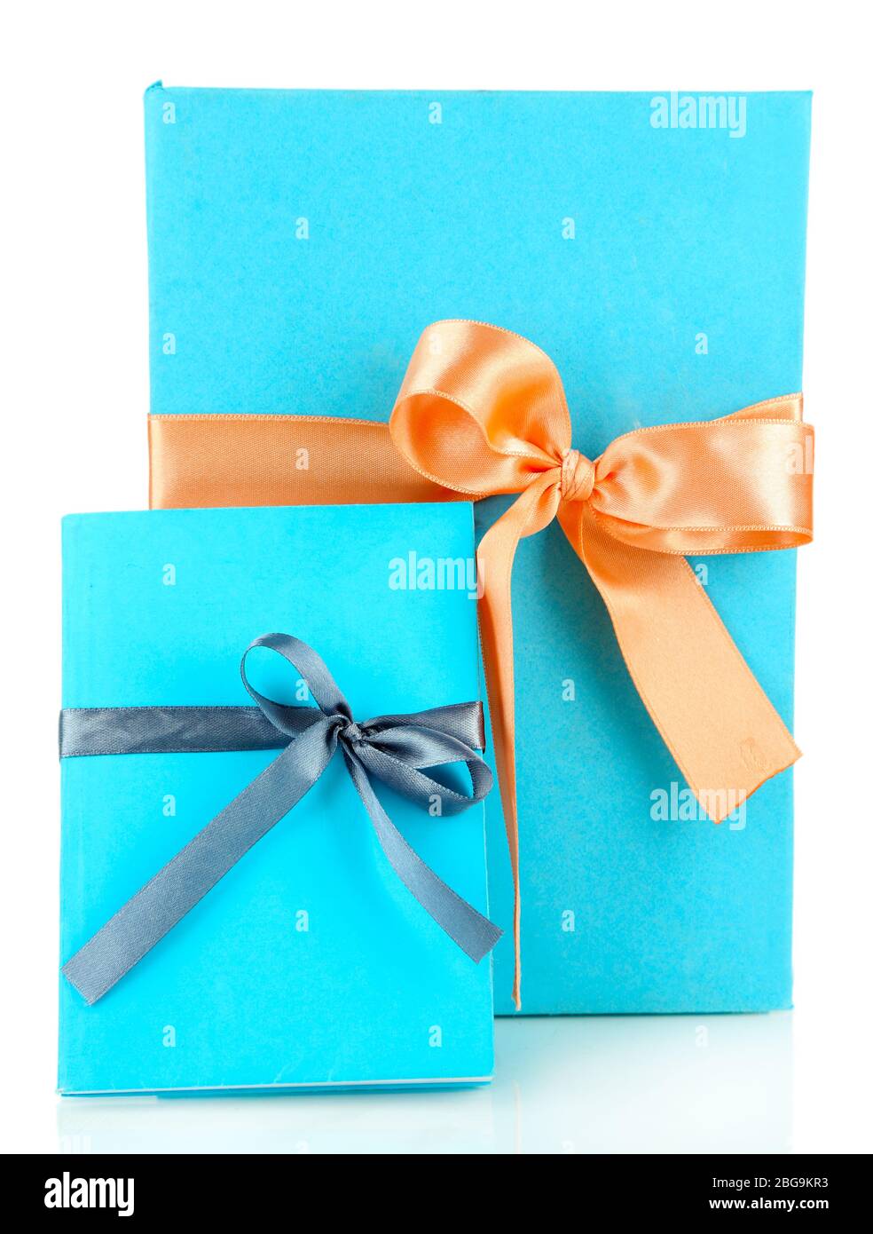 Books wrapped with color ribbons, isolated on white Stock Photo - Alamy