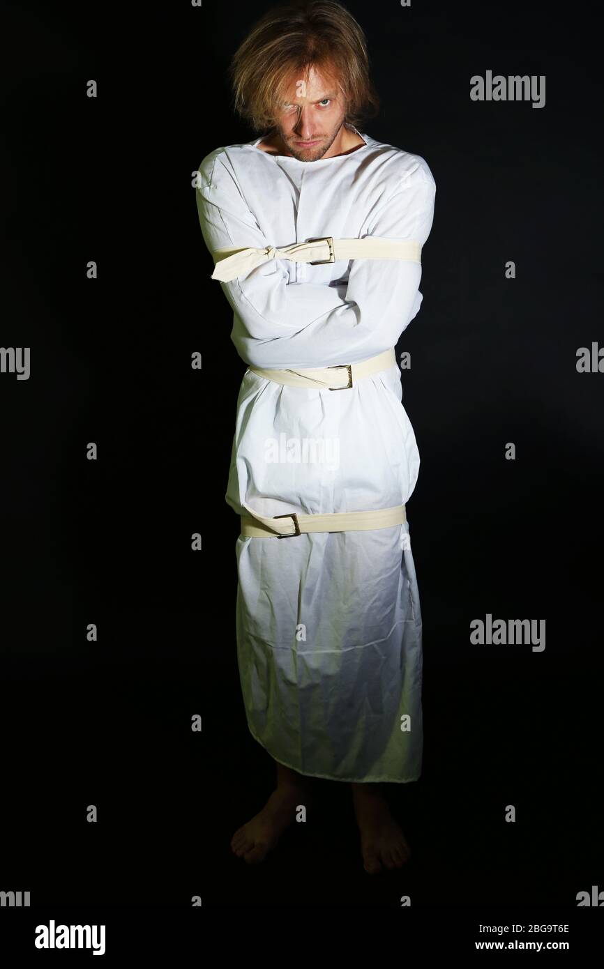 Mentally ill man in straitjacket on black background Stock Photo Alamy