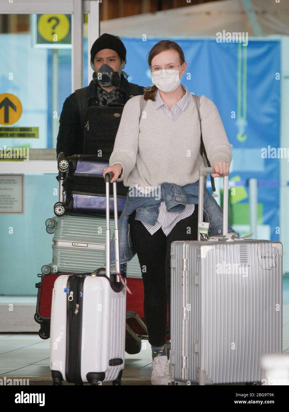 Vancouver, Canada. 20th Apr, 2020. Travellers wearing face masks are seen at the arrival hall of Vancouver International Airport in Richmond, Canada, April 20, 2020. Credit: Liang Sen/Xinhua/Alamy Live News Stock Photo