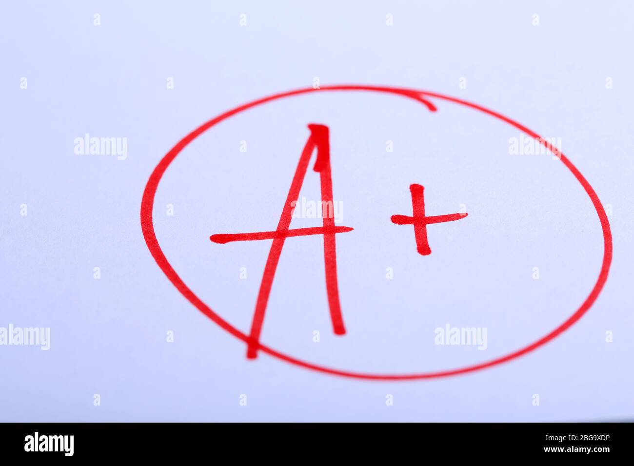 Grade A+ written on an exam paper Stock Photo - Alamy