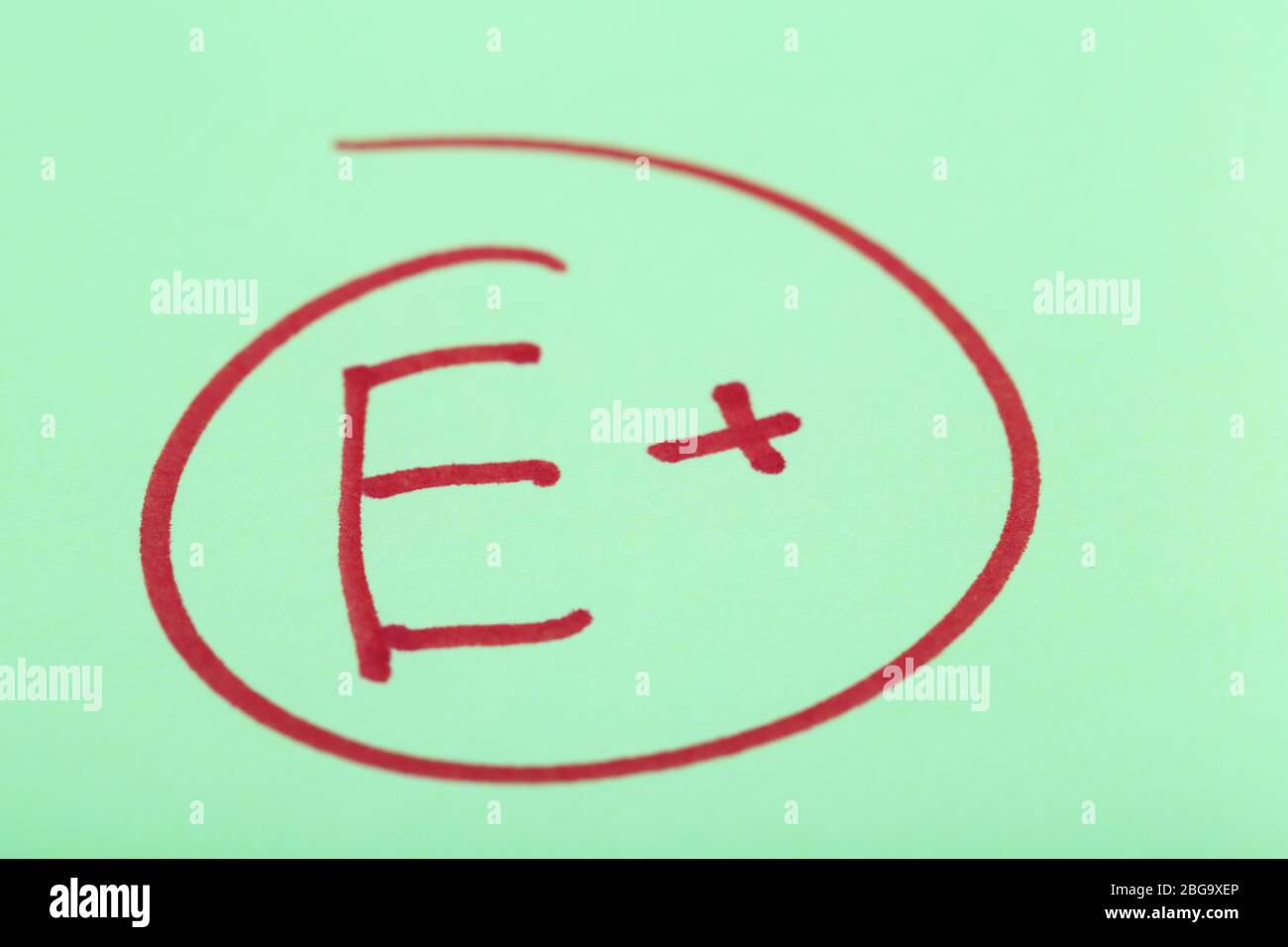 Grade E+ written on an exam paper Stock Photo - Alamy