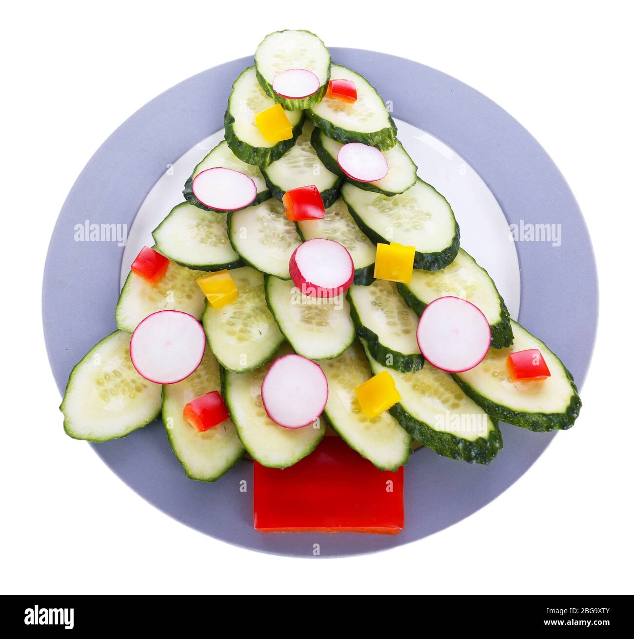 Christmas tree from cucumber on plate isolated on white Stock Photo