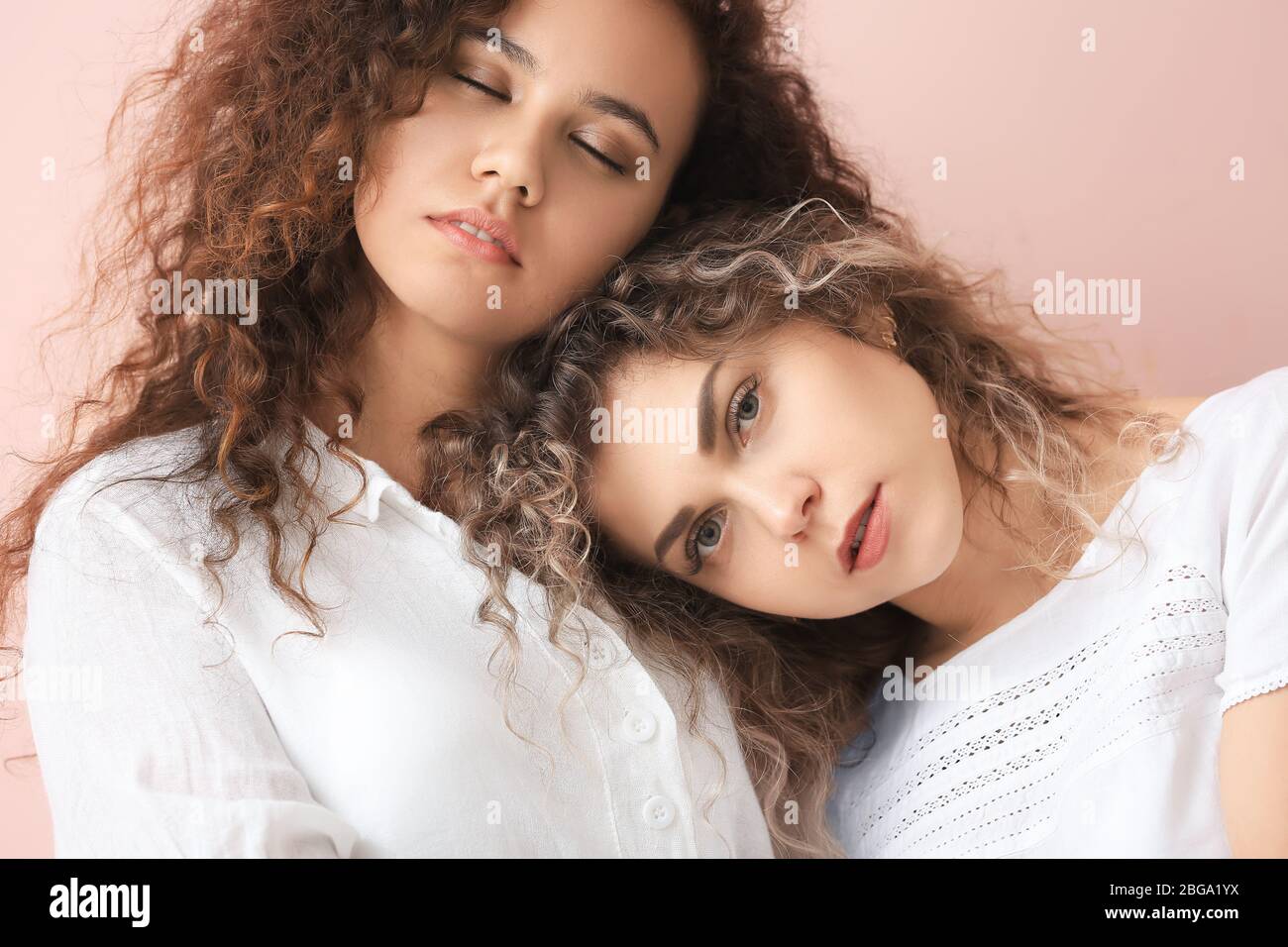 Beautiful young women on color background Stock Photo - Alamy