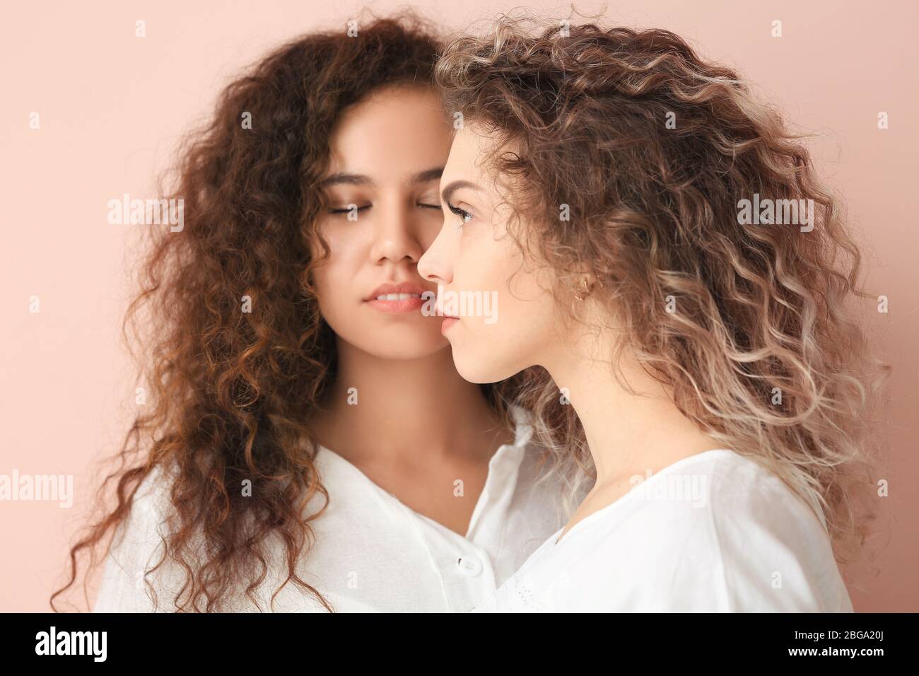 Beautiful young women on color background Stock Photo - Alamy