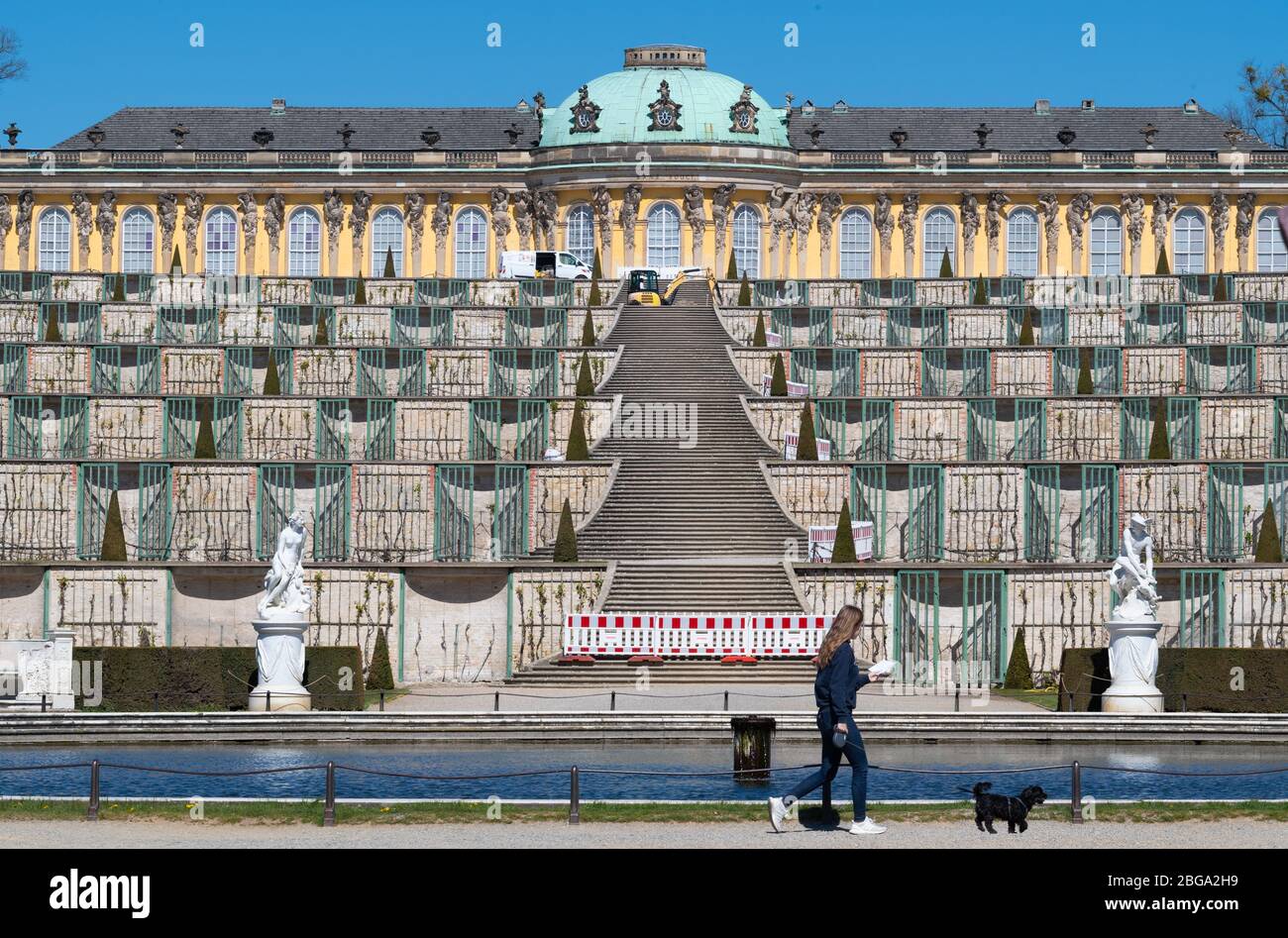 20 April 2020, Brandenburg, Potsdam: A red and white barrier is placed in front of the stairs below the vineyard terraces of Sanssouci Castle. Workers have begun the restoration of the central axis on behalf of the Prussian Palaces and Gardens Foundation Berlin-Brandenburg (SPSG). The treads between the terrace stairs are to be fortified with bound stones, thus preserving the historic sandstone steps. Up to now, the stairs have also been subject to heavy wear and tear due to gravel that has entered shoe treads. According to the foundation, the work is expected to be completed on 20 May 2020. P Stock Photo