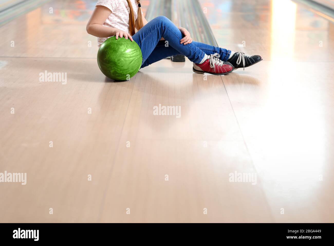 Little girl playing bowling in club Stock Photo Alamy