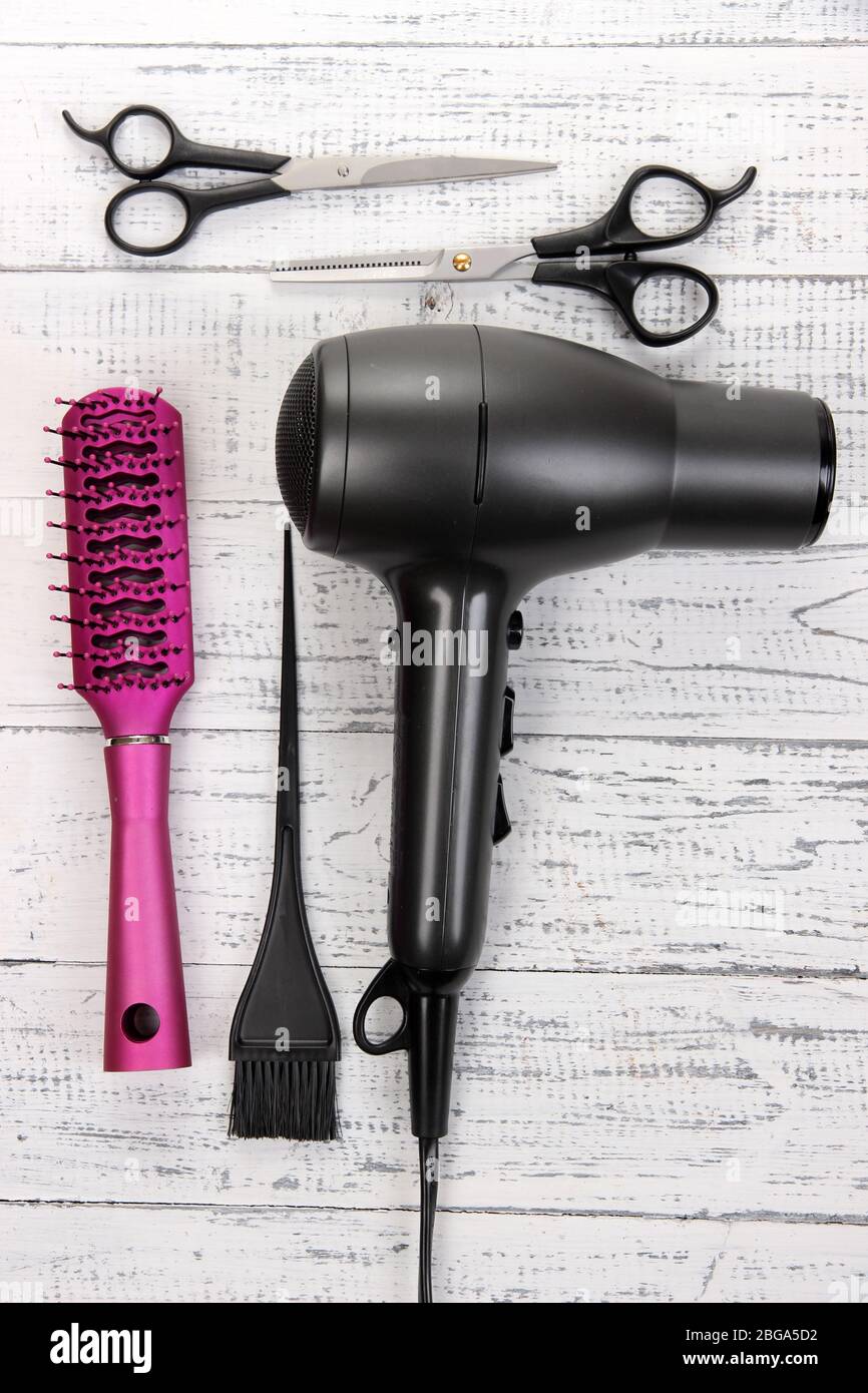 Hairdressing tools on white wooden table close-up Stock Photo