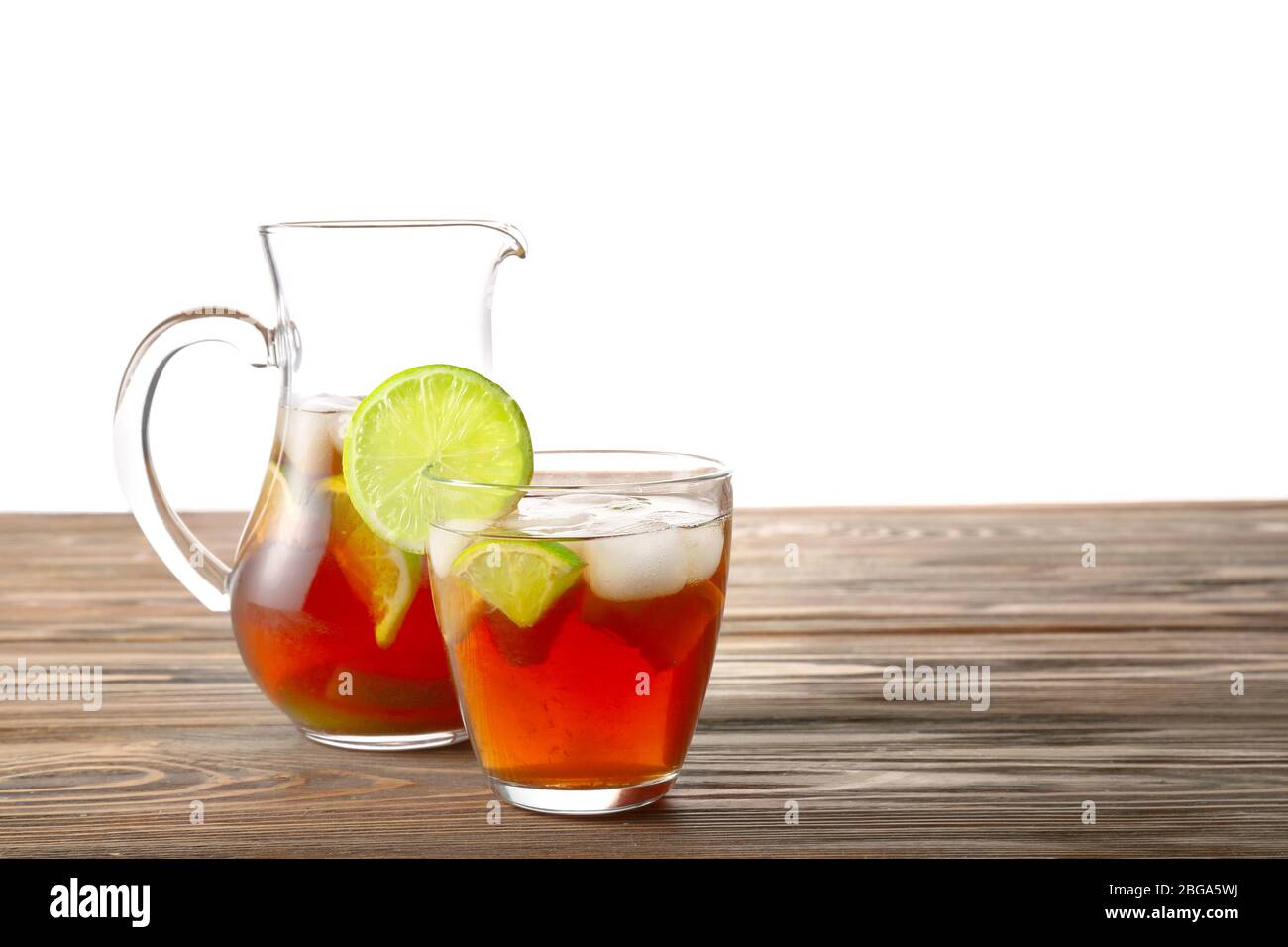 https://c8.alamy.com/comp/2BGA5WJ/glass-and-jug-of-tasty-cold-ice-tea-on-table-against-white-background-2BGA5WJ.jpg