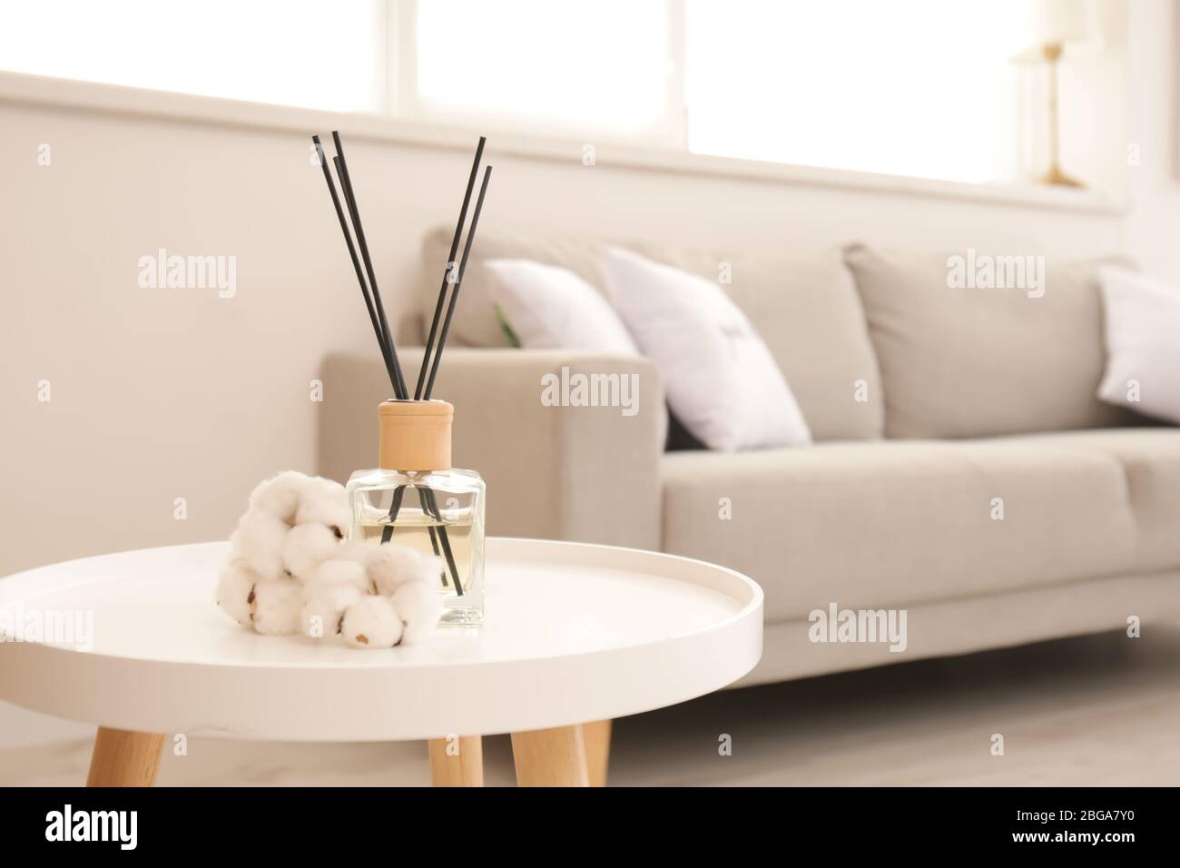 Reed diffuser on table in living room Stock Photo - Alamy
