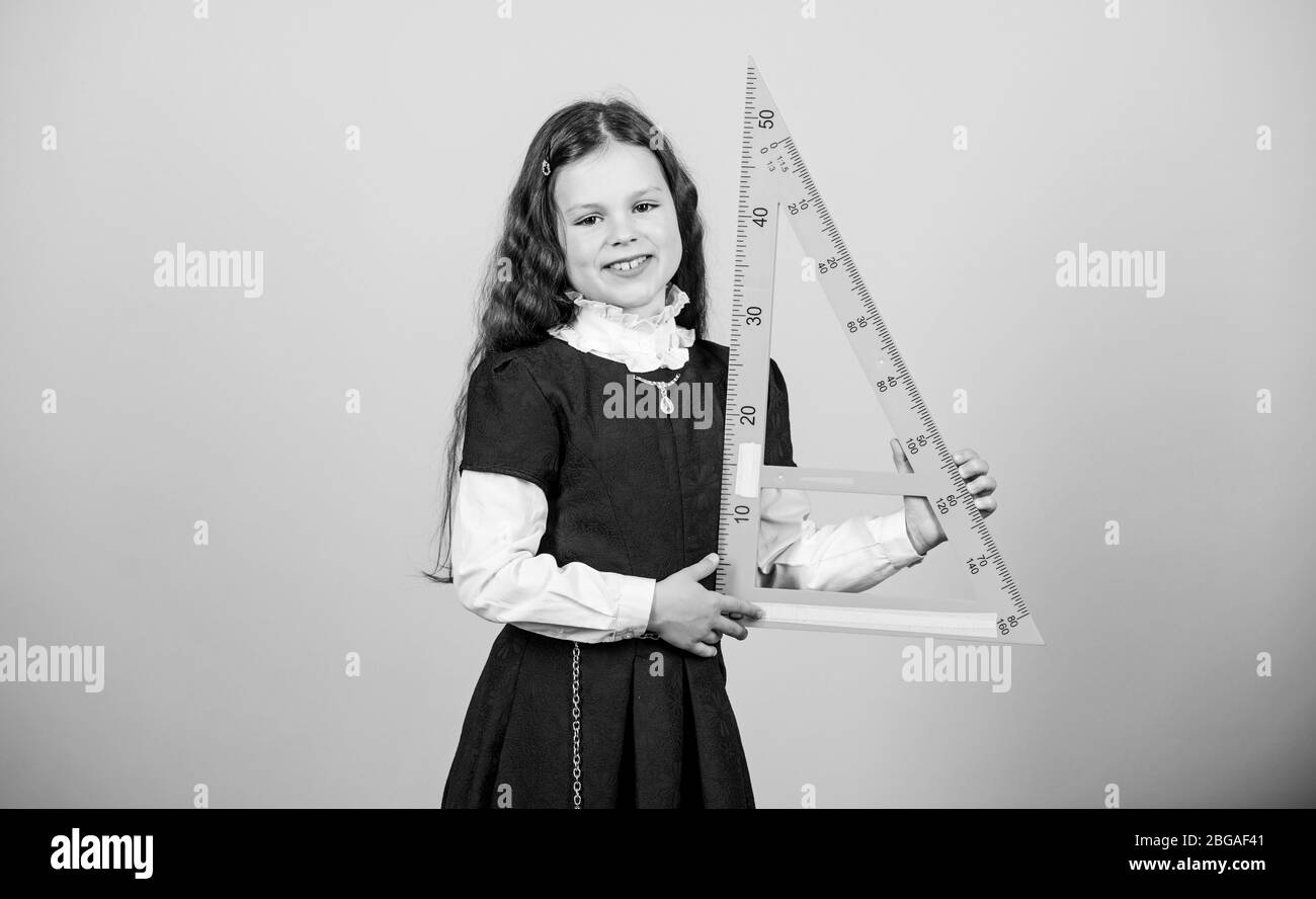 Smart and clever concept. Girl with big ruler. School student study