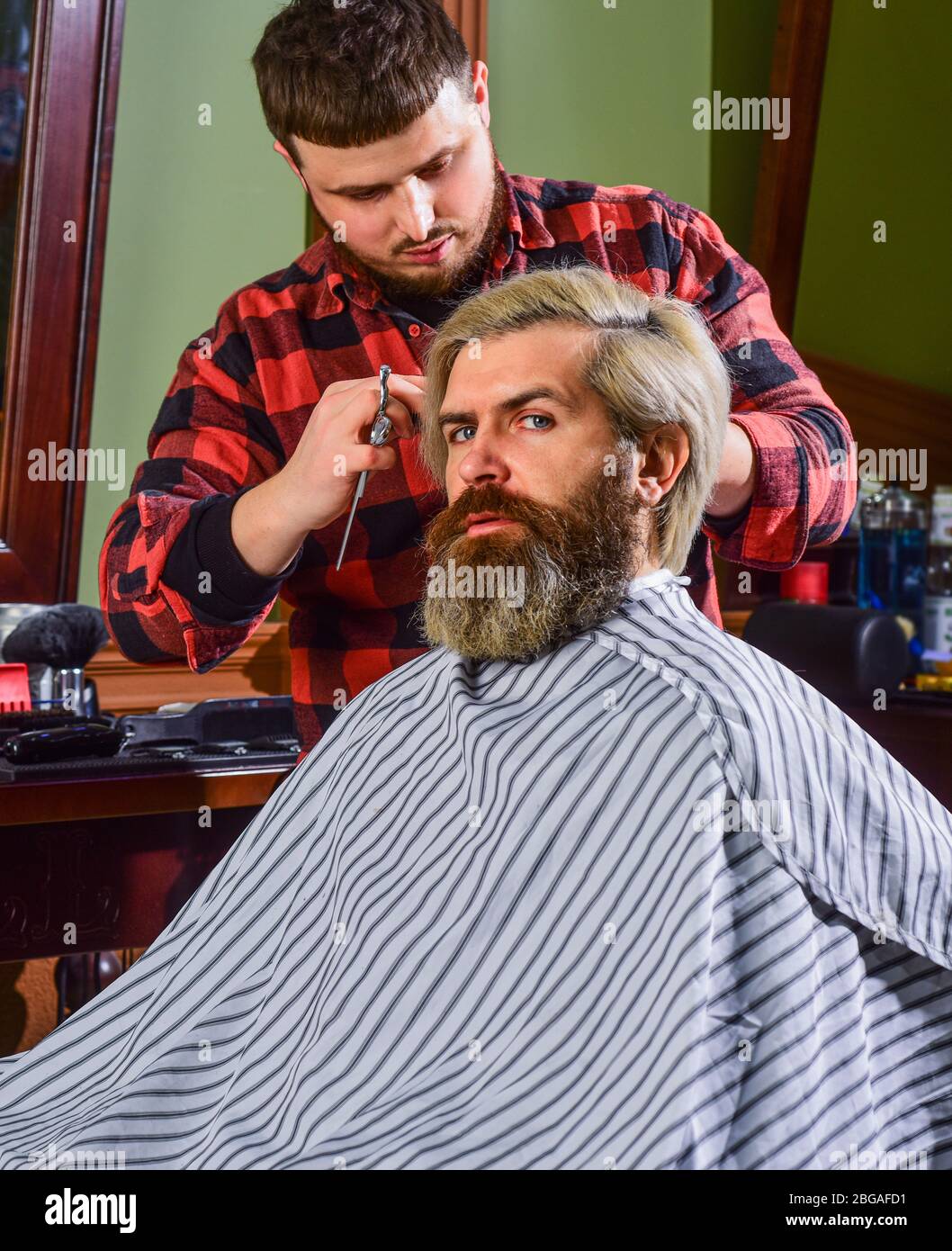 handsome male. barber tools in barbershop. handsome hairdresser cutting ...