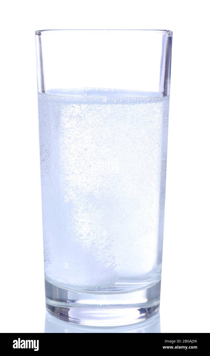 Glass with efervescent tablet in water with bubbles isolated on white Stock Photo