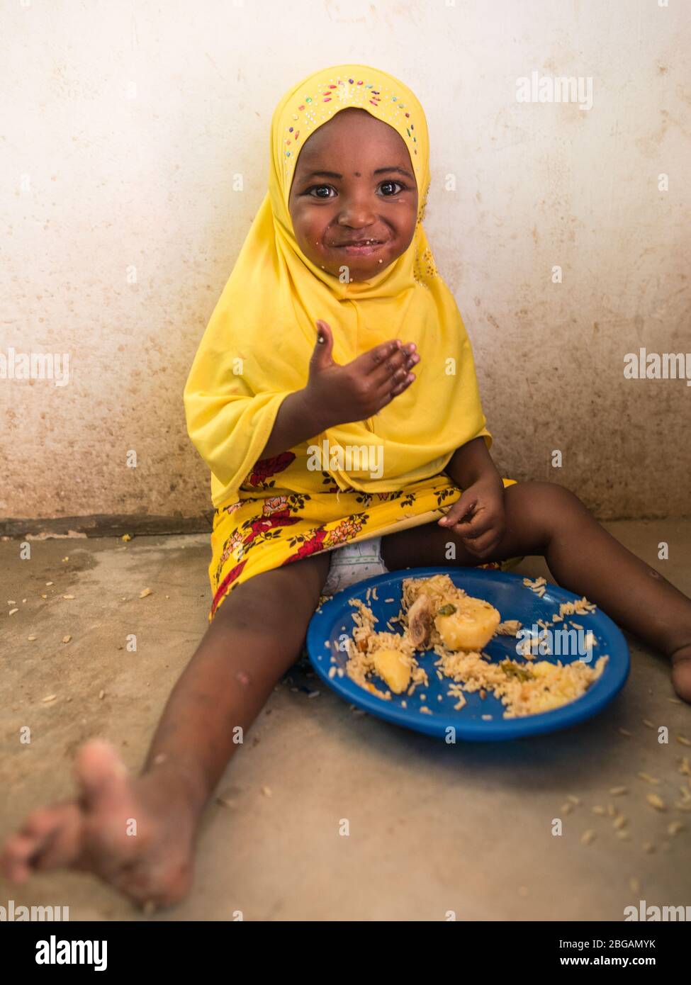 Lamu, Kenya December 15, 2016 African cute kid eating rice with