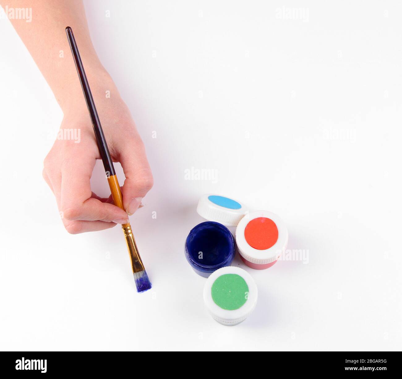 Hand holding brush with paints isolated on white Stock Photo - Alamy