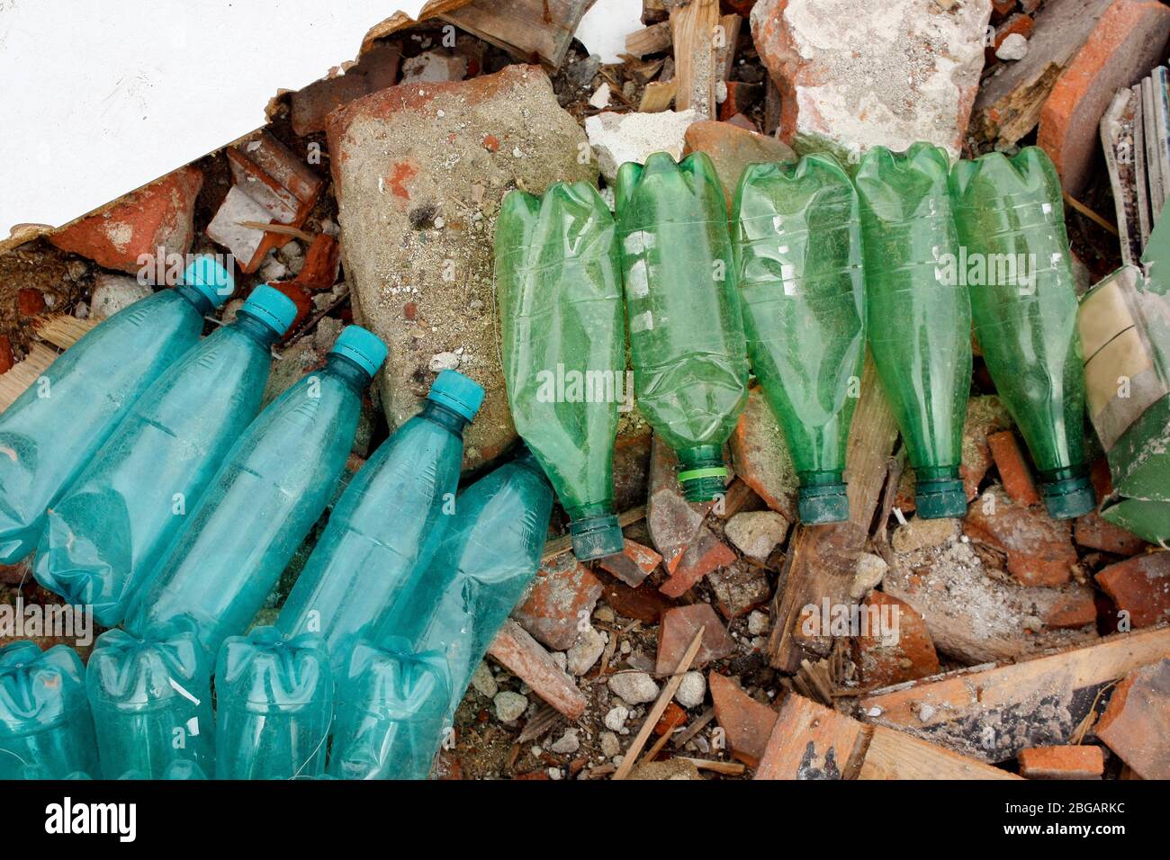 Dirty used plastic bottles pollution. Plastic waste and construction site waste. Stock Photo