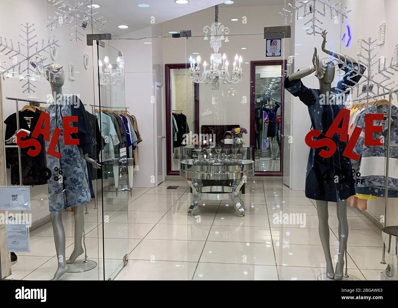 Teheran, Iran. 20th Apr, 2020. Window dressers are located in a boutique in  the Palladium shopping mall. On Monday in Tehran the corona restrictions  were further relaxed and the larger department stores